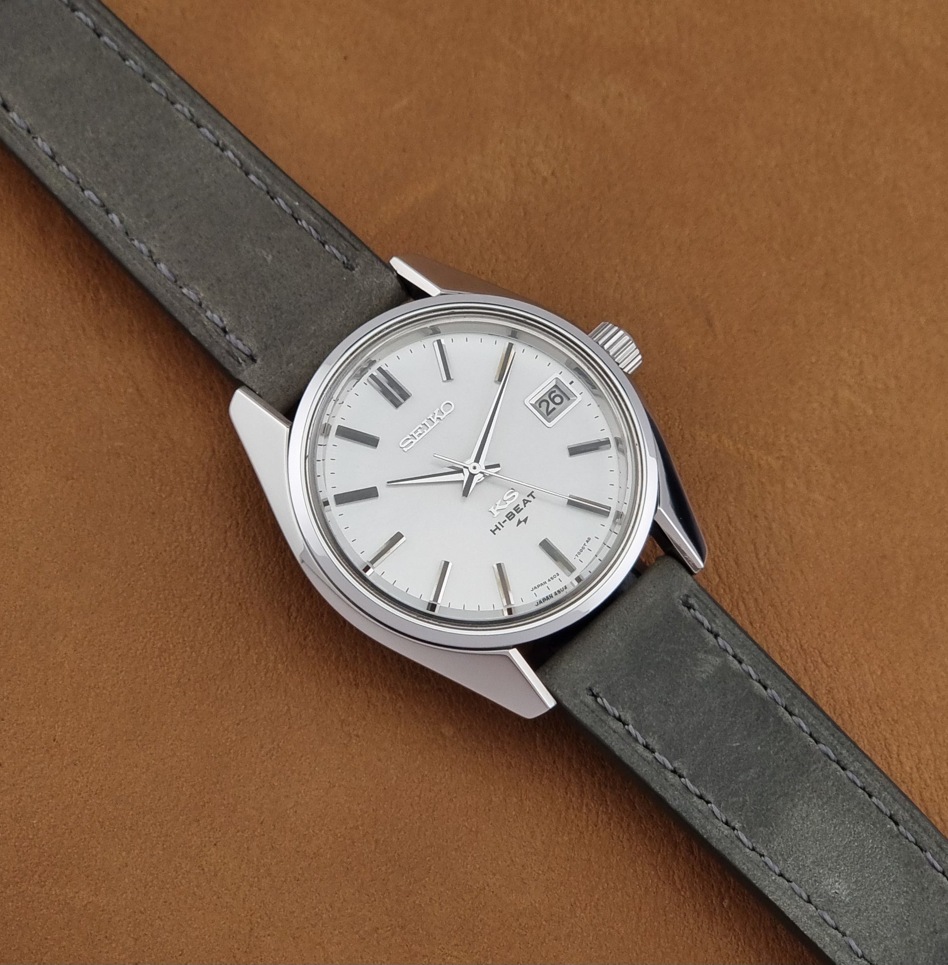 Vintage King Seiko 4502-7001 watch with a white dial on brown background dial