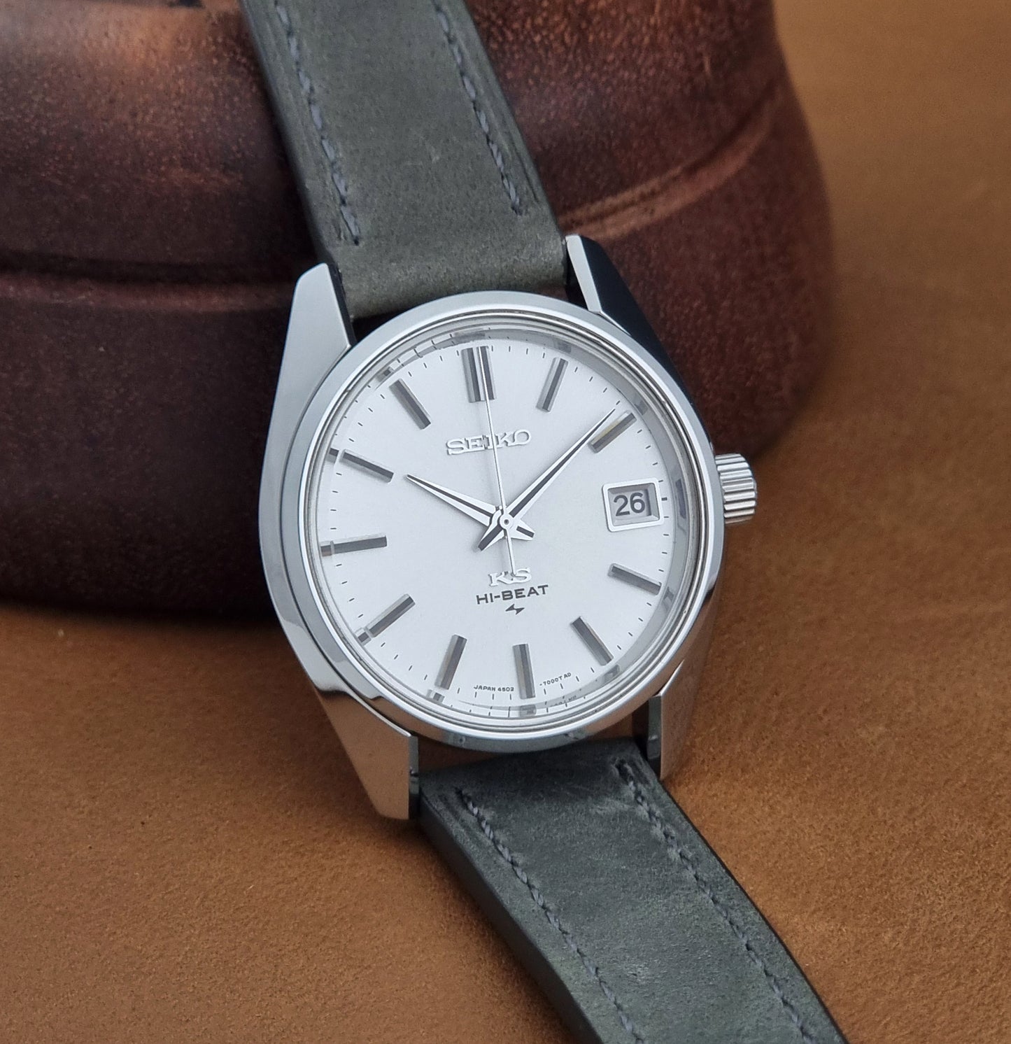 Vintage King Seiko 4502-7001 watch with a white dial on brown background side view