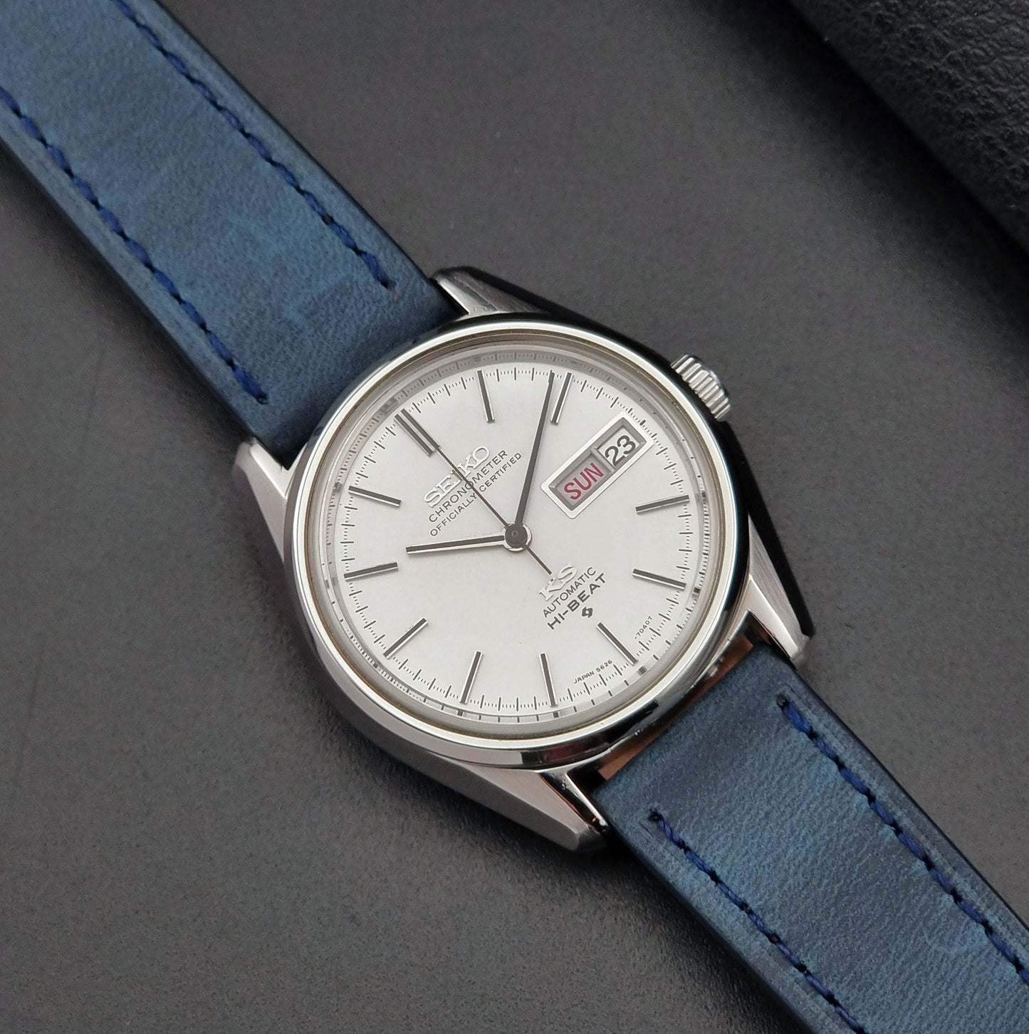 King Seiko Wristwatch with blue strap on a gray background