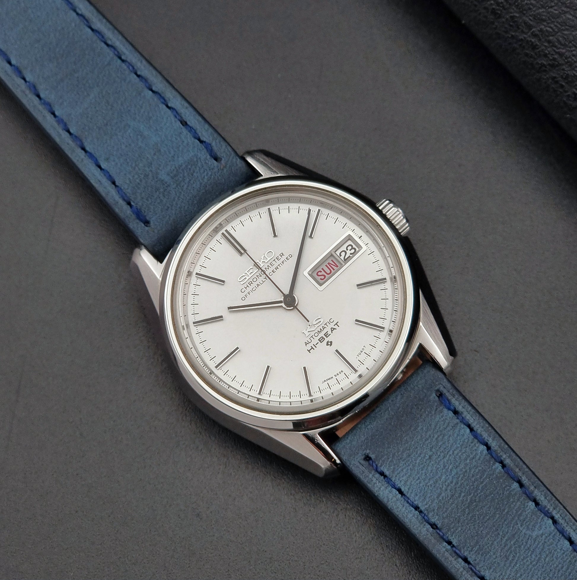 King Seiko Wristwatch with blue strap on a gray background