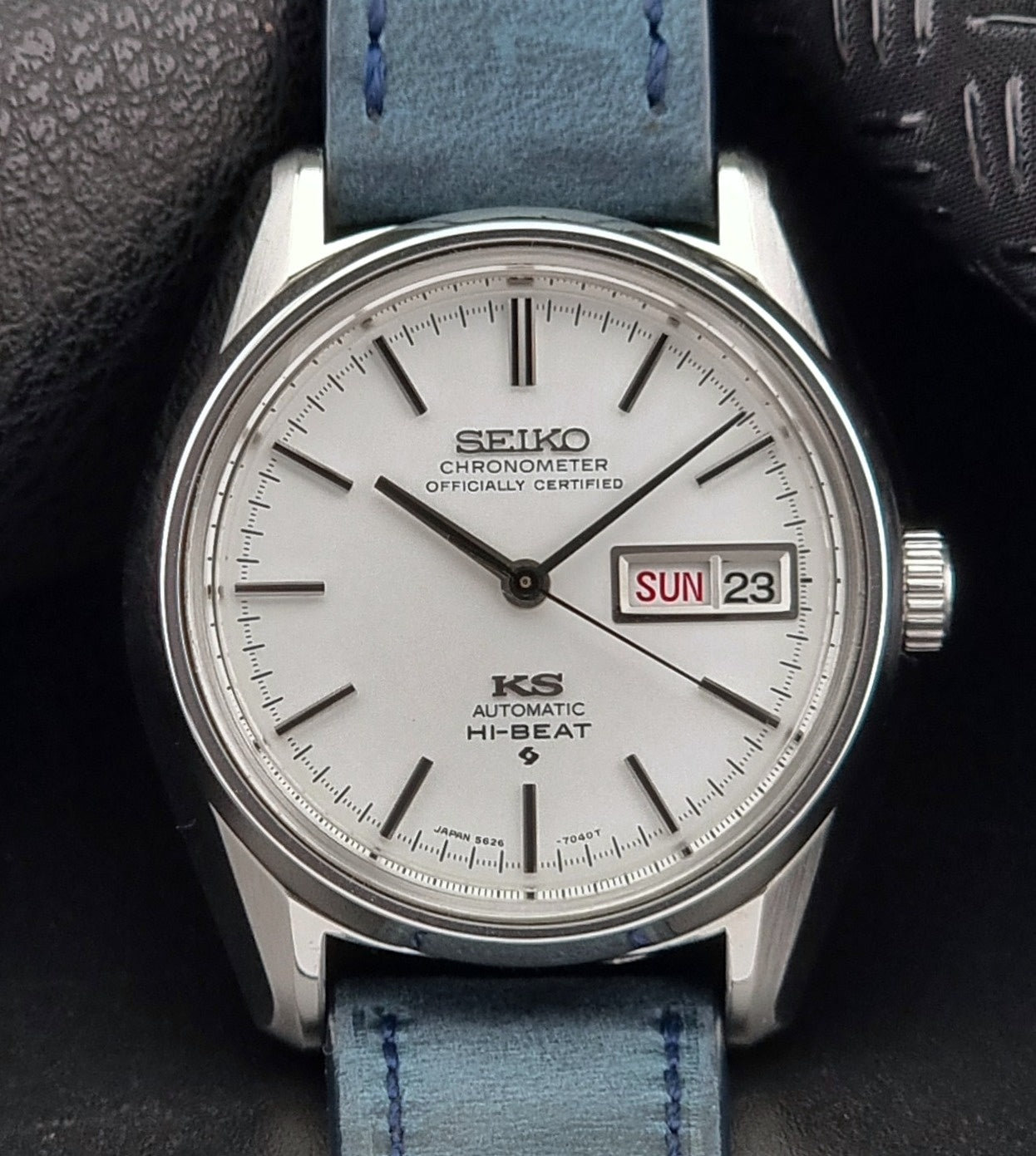 Seiko watch with a blue strap on a dark background