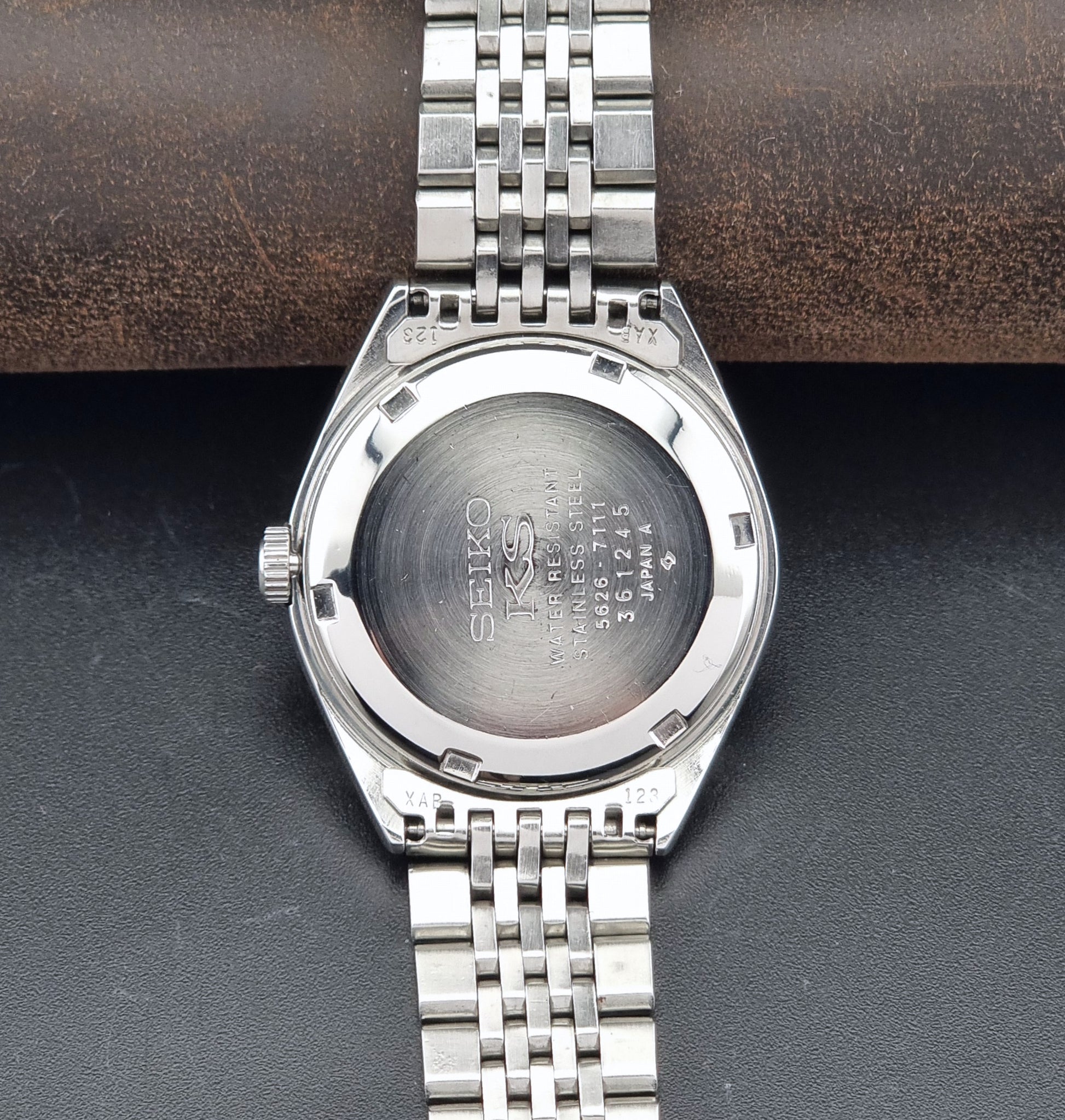 Vintage King Seiko 5626-7111 Wristwatch with white dial on a dark background caseback view