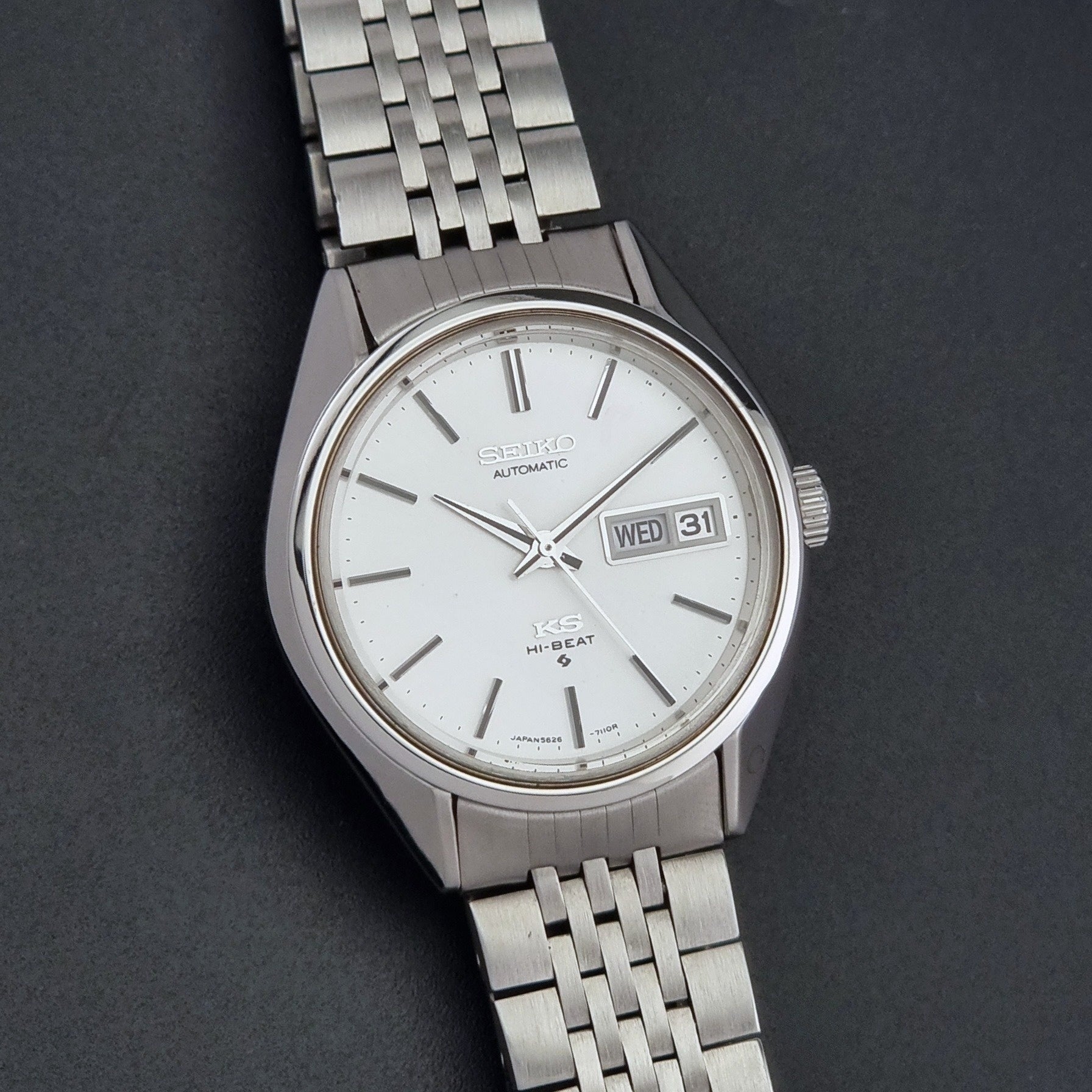 Vintage King Seiko 5626-7111 Wristwatch with white dial on a dark background close up dial view
