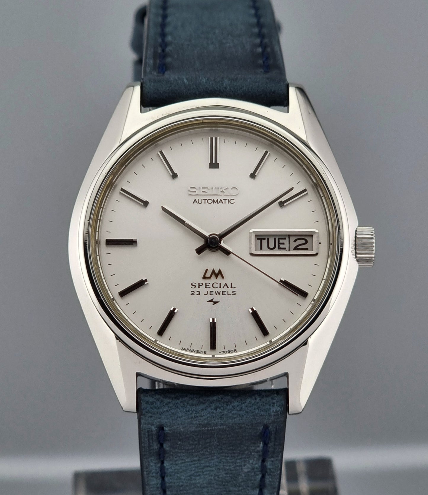 Seiko Wristwatch LordMatic Special 5216-7080 Vintage 1974 with blue leather strap on a gray surface