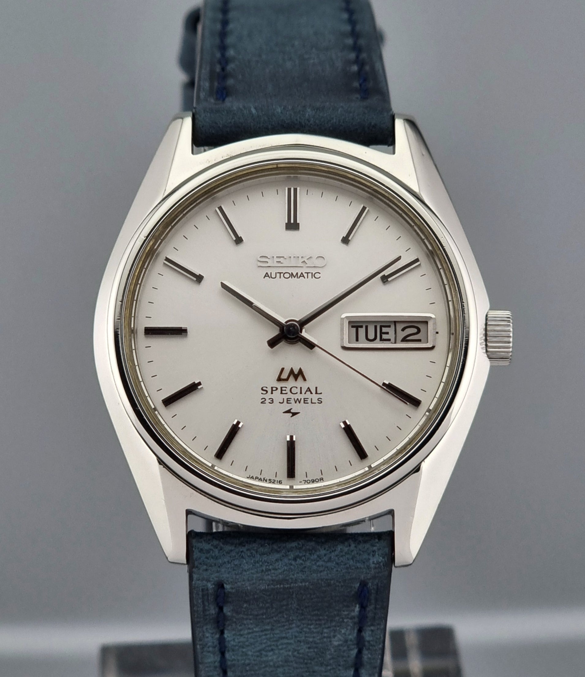 Seiko Wristwatch LordMatic Special 5216-7080 Vintage 1974 with blue leather strap on a gray surface