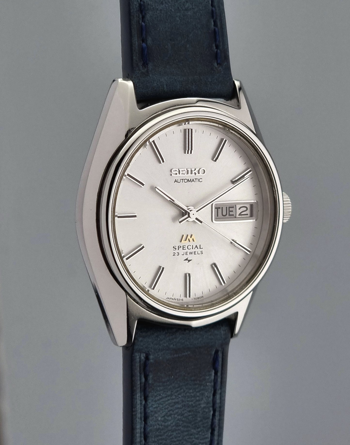 Seiko Wristwatch LordMatic Special 5216-7080 Vintage 1974 with blue leather strap on a gray surface