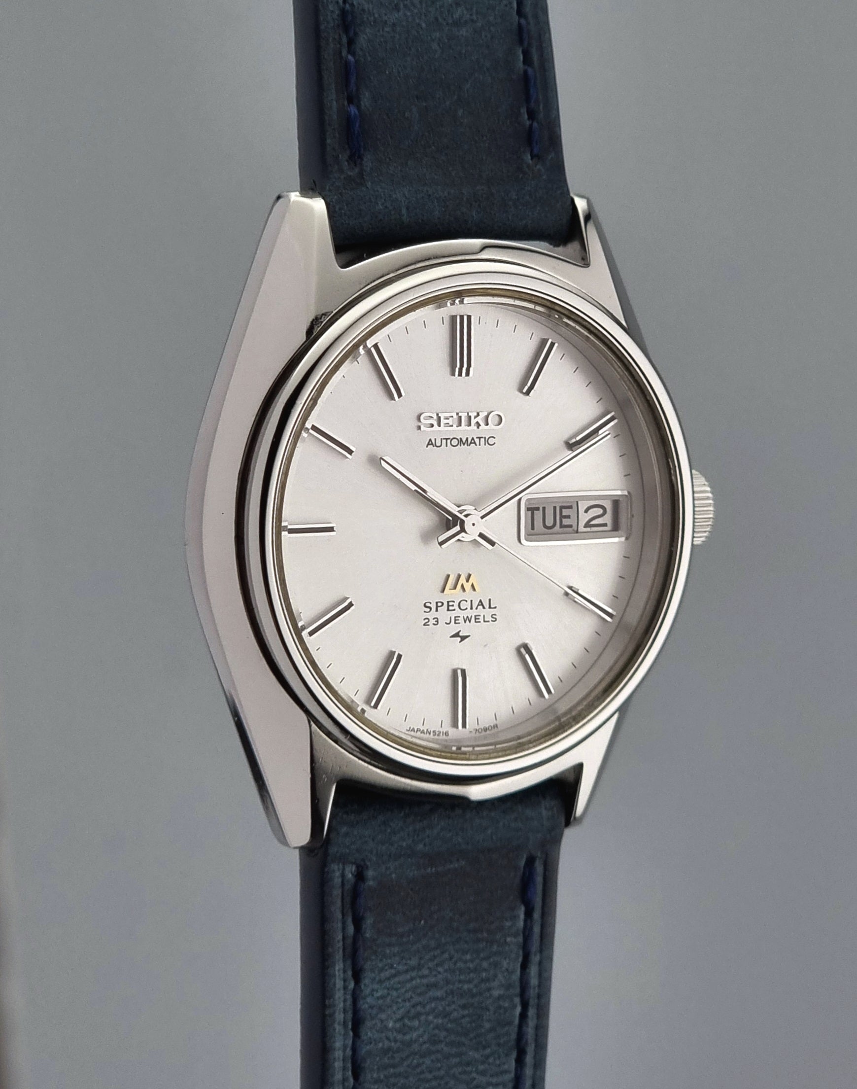 Seiko Wristwatch LordMatic Special 5216-7080 Vintage 1974 with blue leather strap on a gray surface
