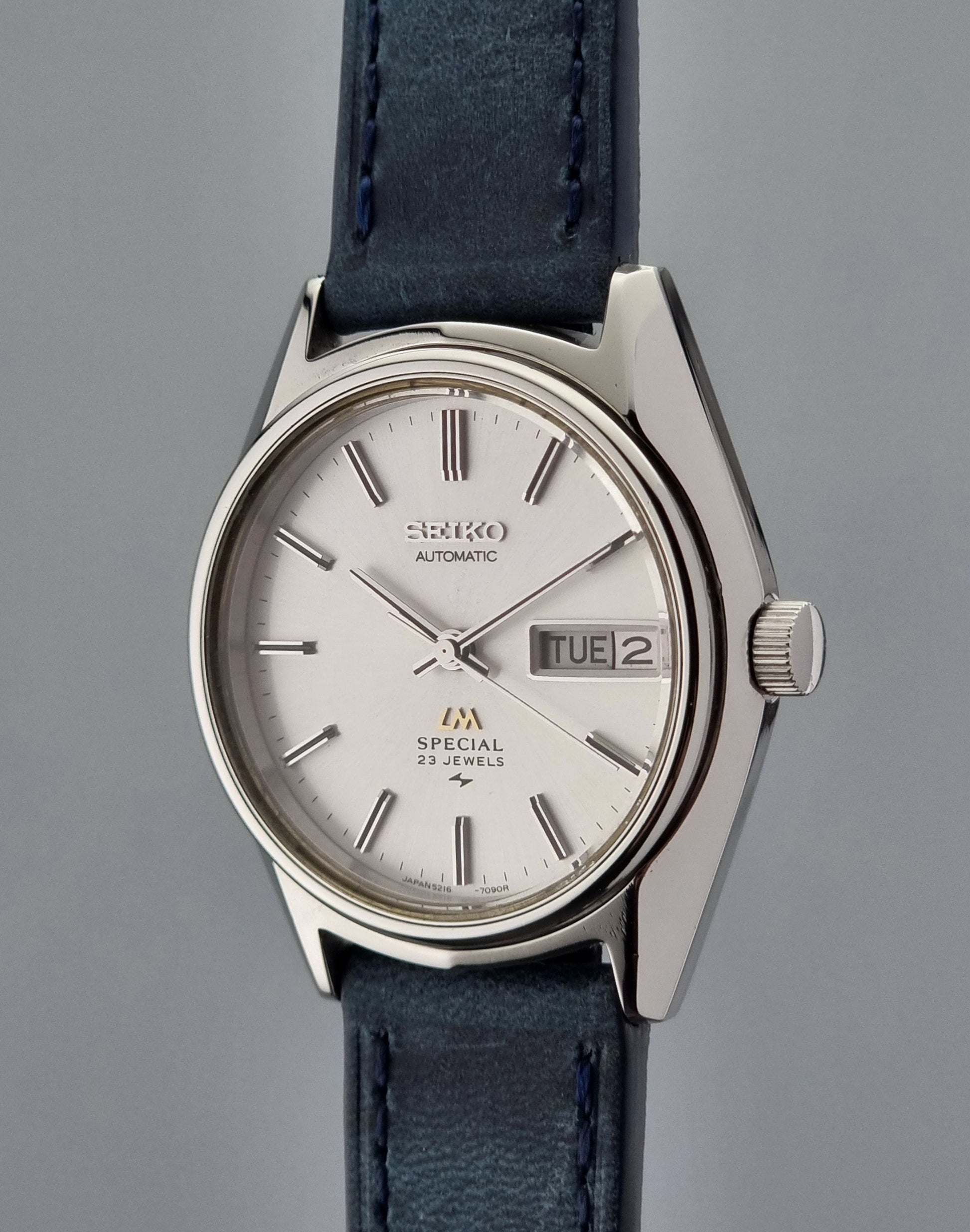Seiko Wristwatch LordMatic Special 5216-7080 Vintage 1974 with blue leather strap on a gray surface