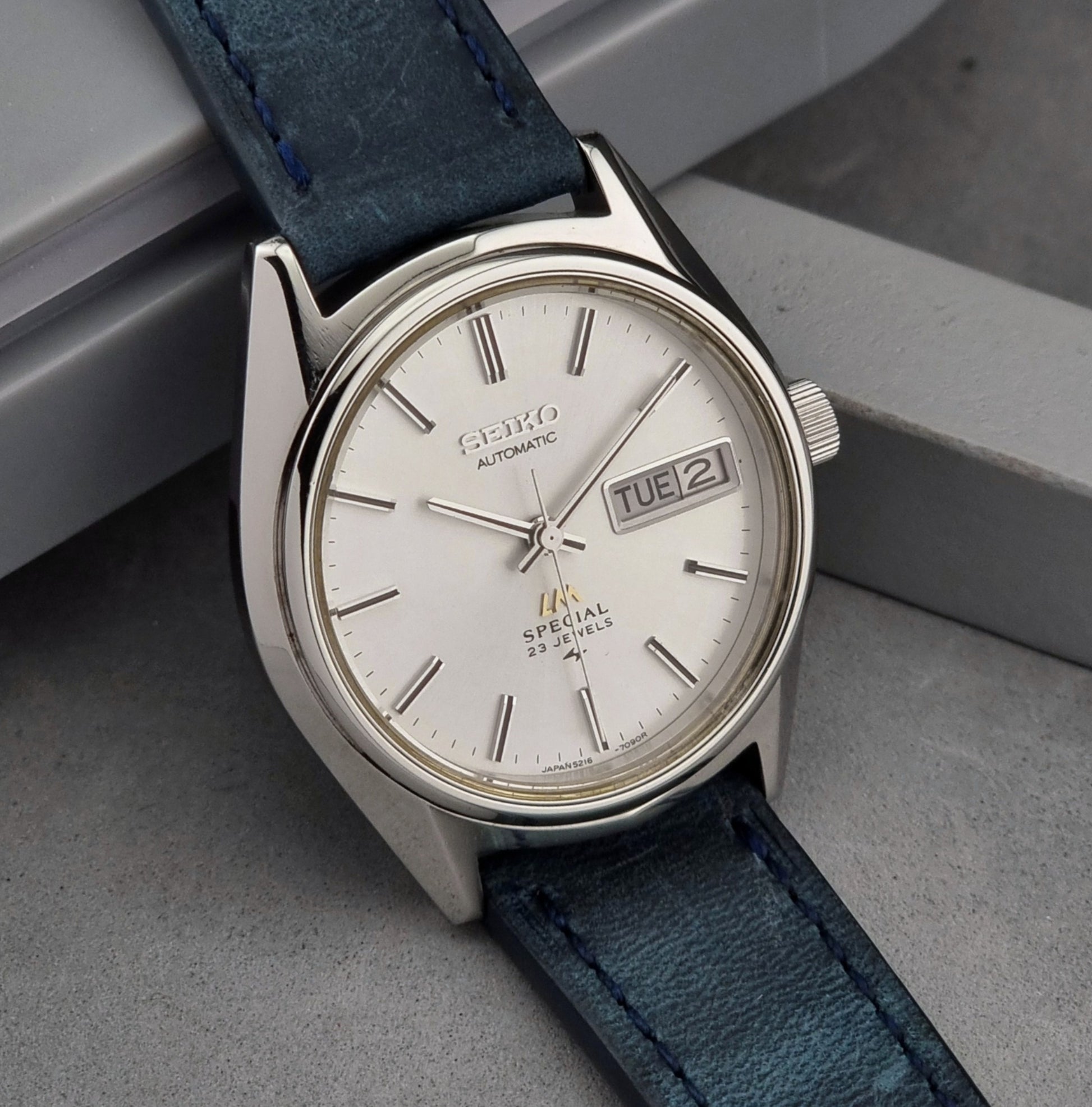 Seiko Wristwatch LordMatic Special 5216-7080 Vintage 1974 with blue strap on a gray surface
