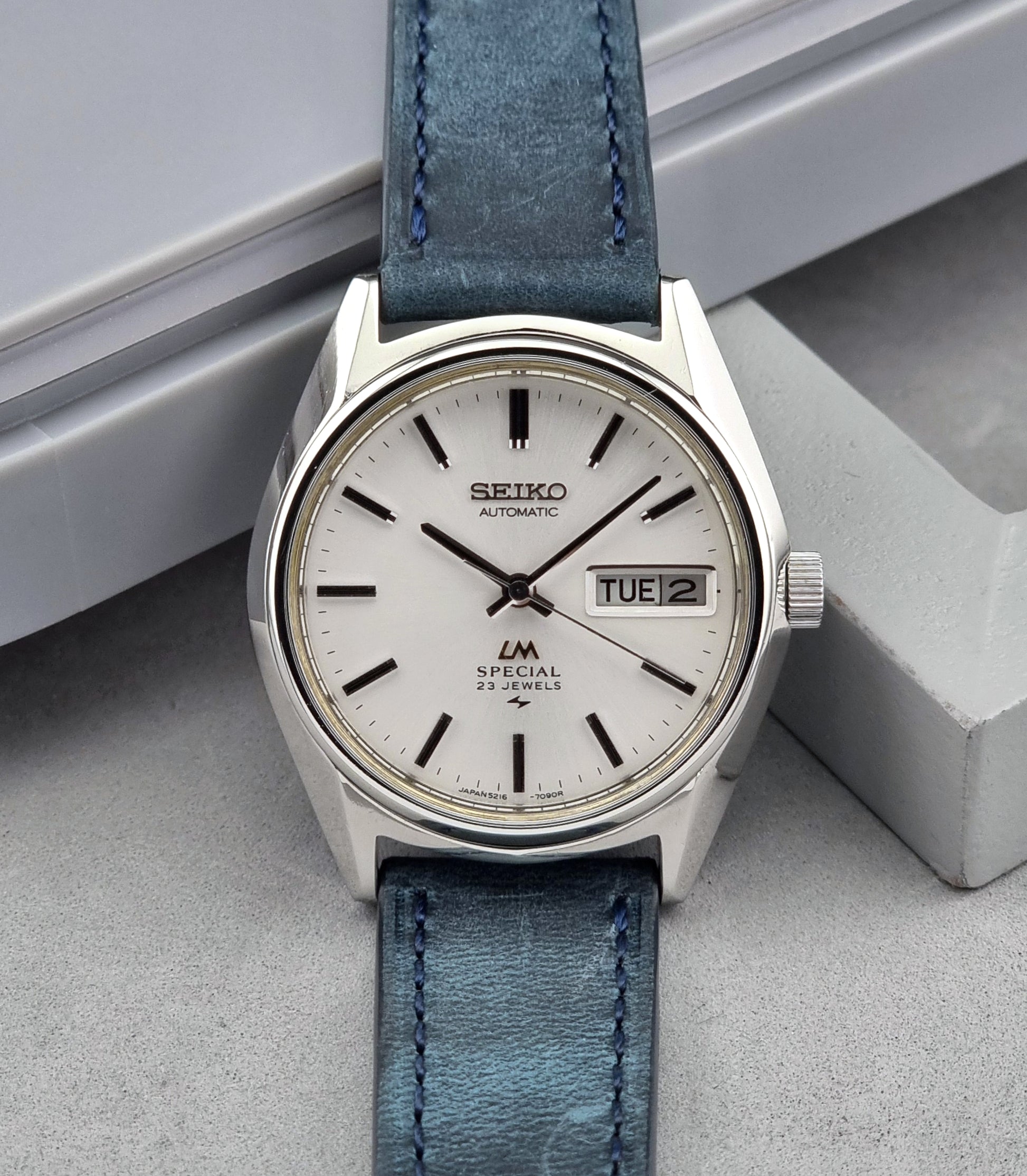 Seiko Wristwatch LordMatic Special 5216-7080 Vintage 1974 with blue leather strap on a gray surface