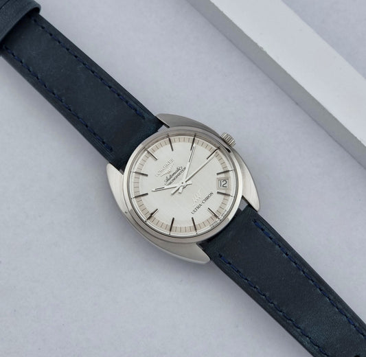 Vintage Longines Wristwatch ULTRA-CHRON 8353-5 Chronometer with a blue leather strap on a light gray background dial