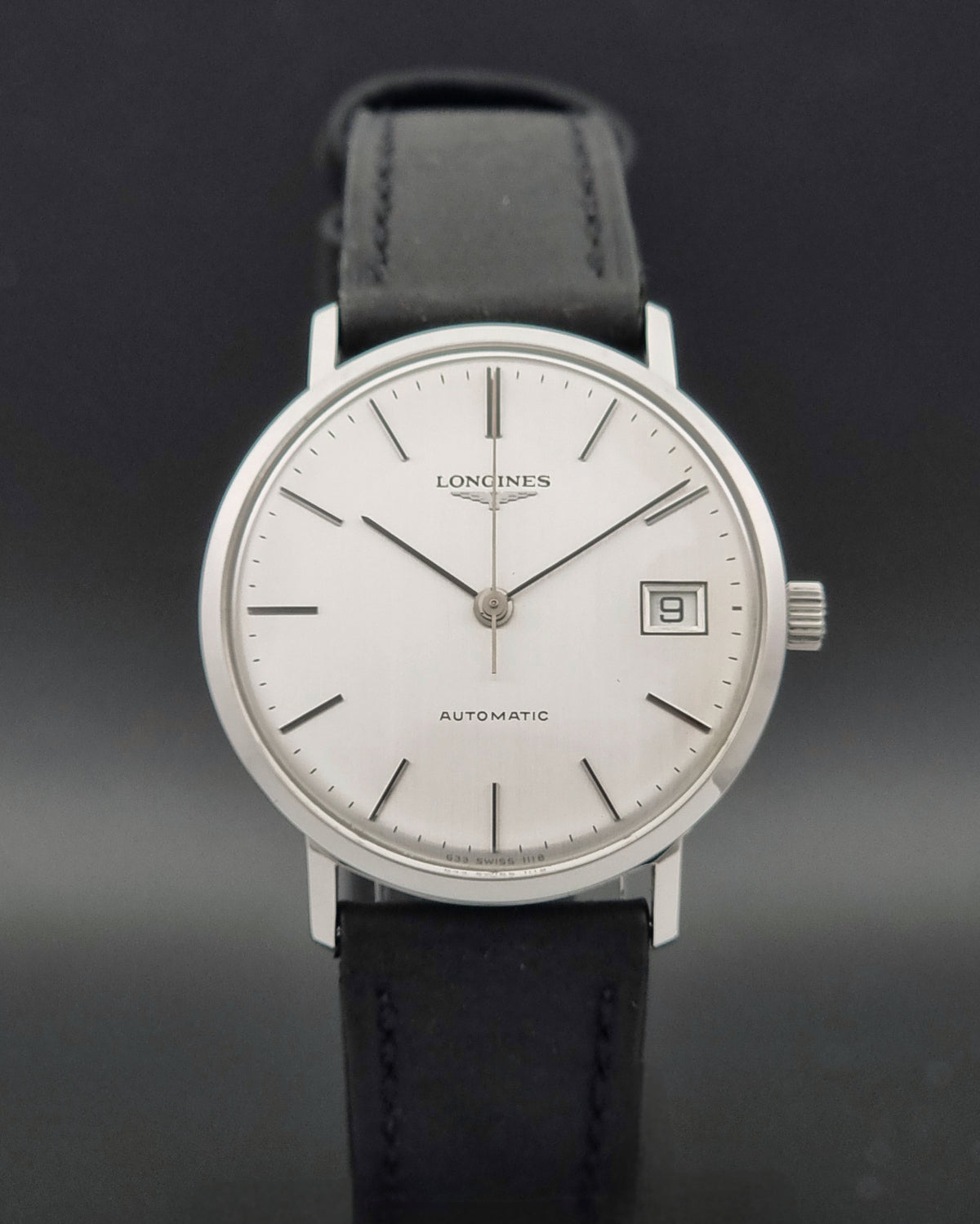 1977 vintage Longines 1118 automatic date watch, dial detail showing applied hour markers and framed date