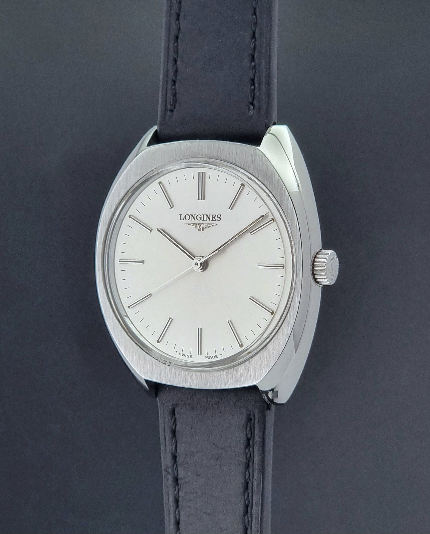 Vintage Longines 1584-1 watch with a black strap on a dark background crown profile view