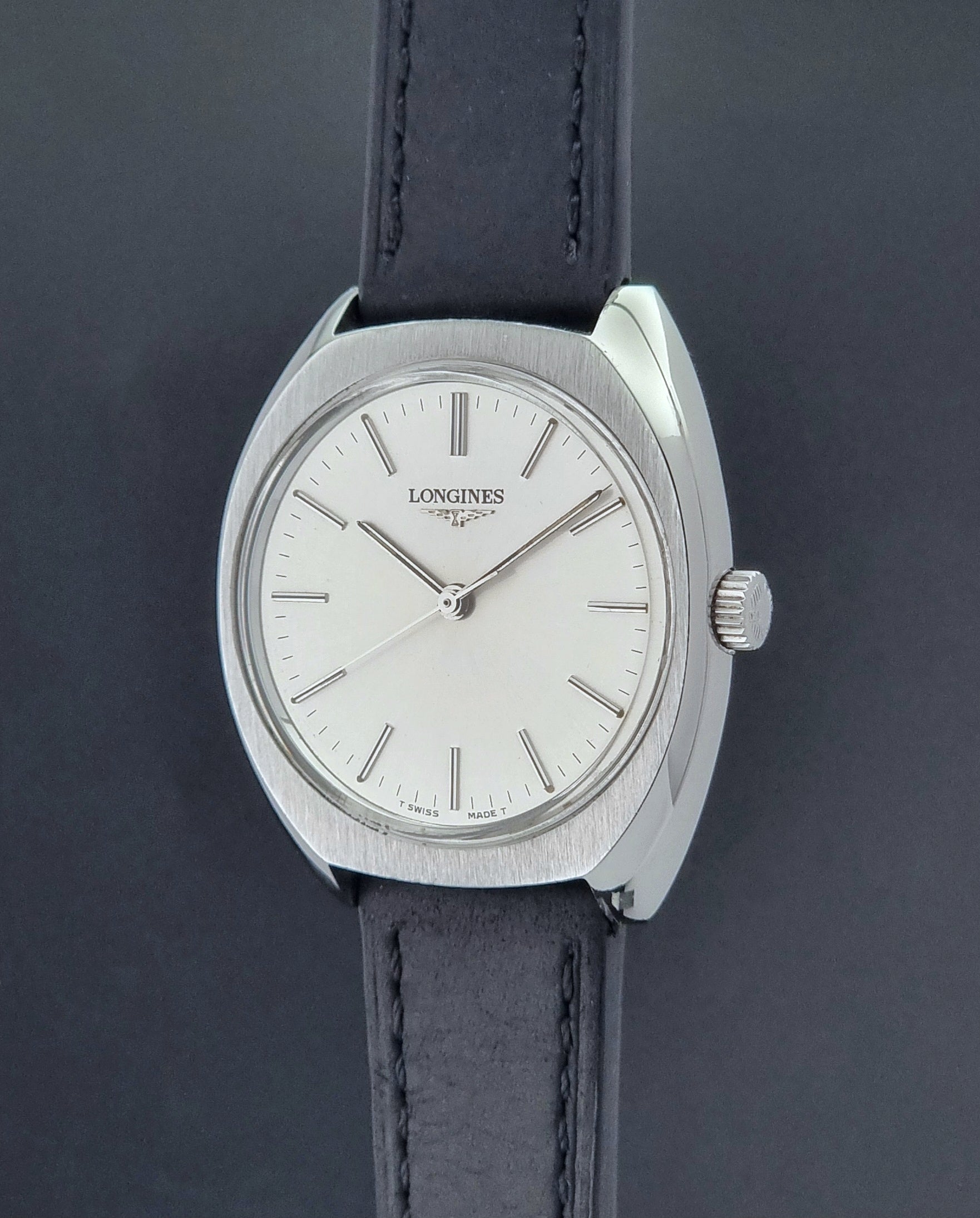 Vintage Longines 1584-1 watch with a black strap on a dark background crown profile view