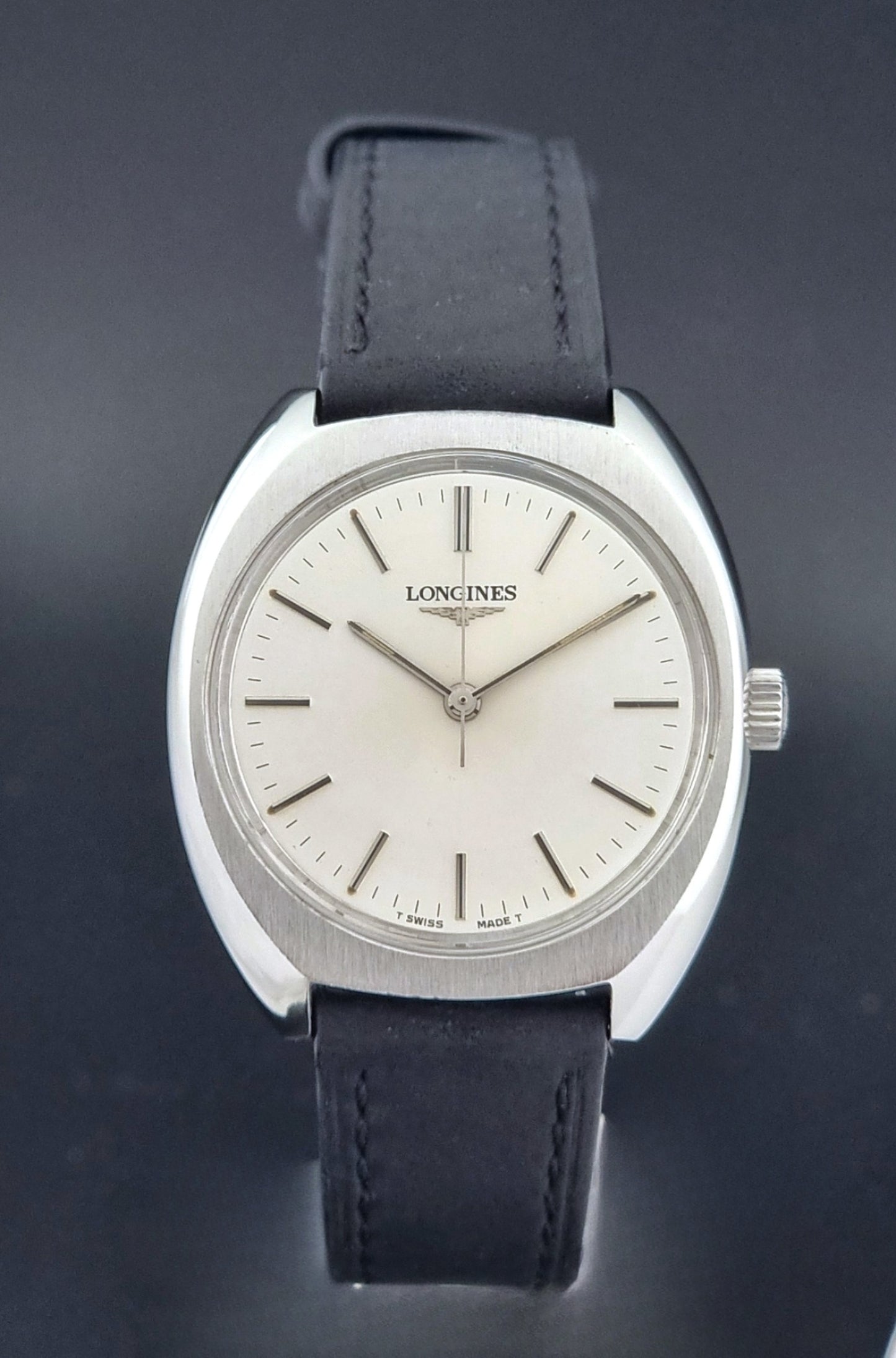 Vintage Longines 1584-1 watch with a black strap on a dark background close dial view