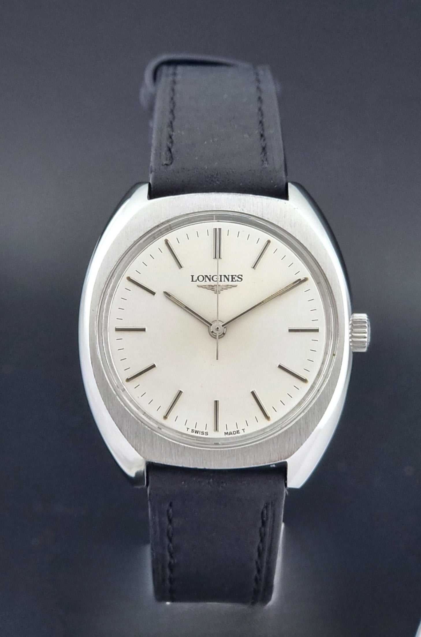 Vintage Longines 1584-1 watch with a black strap on a dark background close dial view