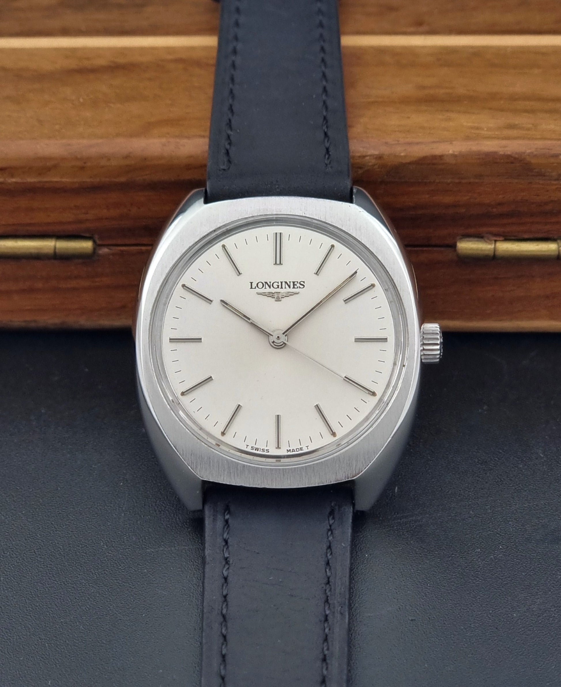 Vintage Longines 1584-1 watch with a black strap on a dark background dial view