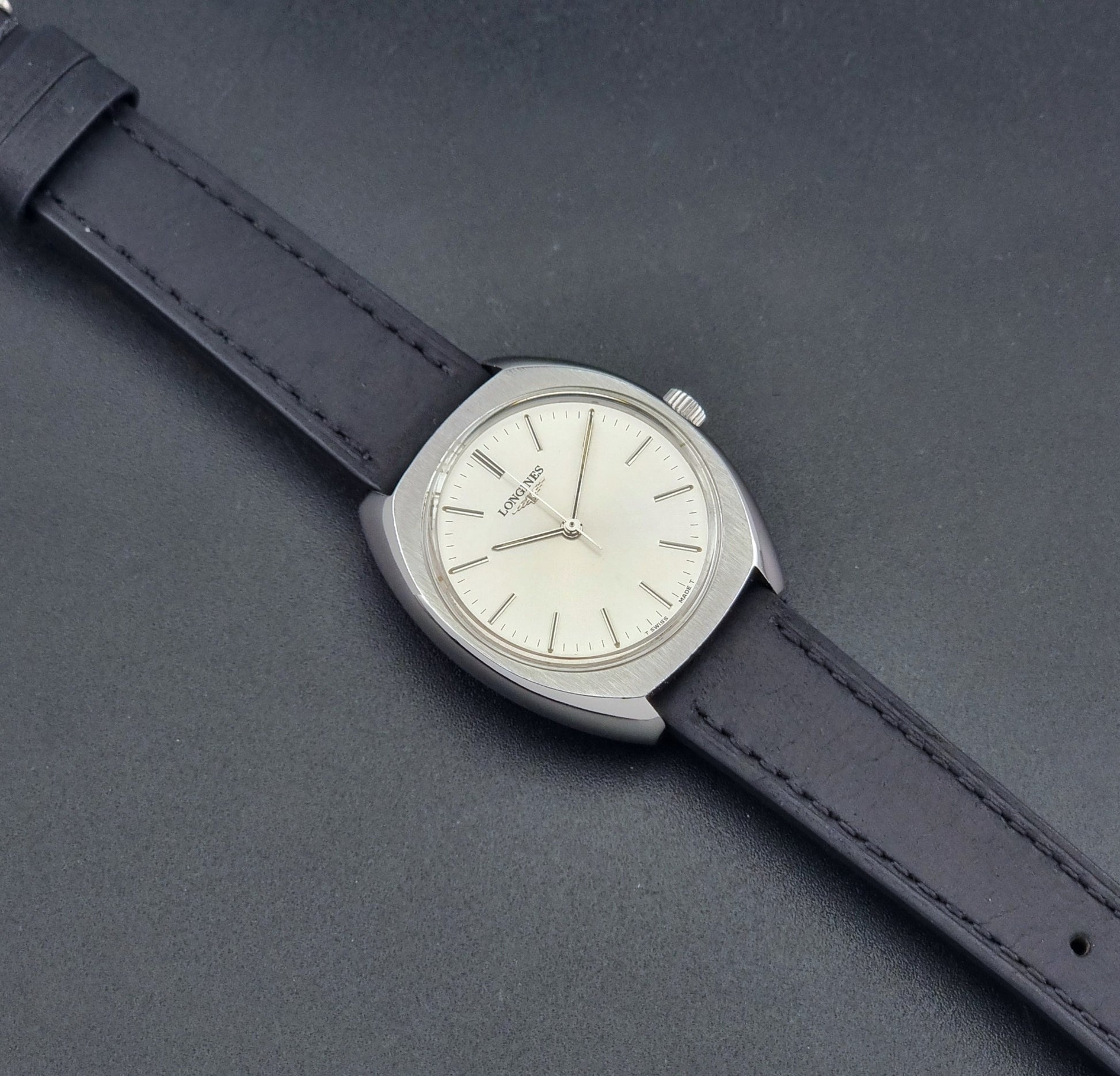 Vintage Longines 1584-1 watch with a black strap on a dark background dial
