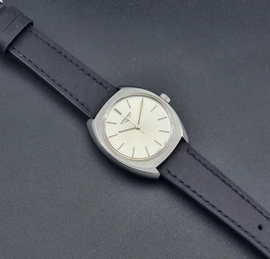 Vintage Longines 1584-1 watch with a black strap on a dark background dial