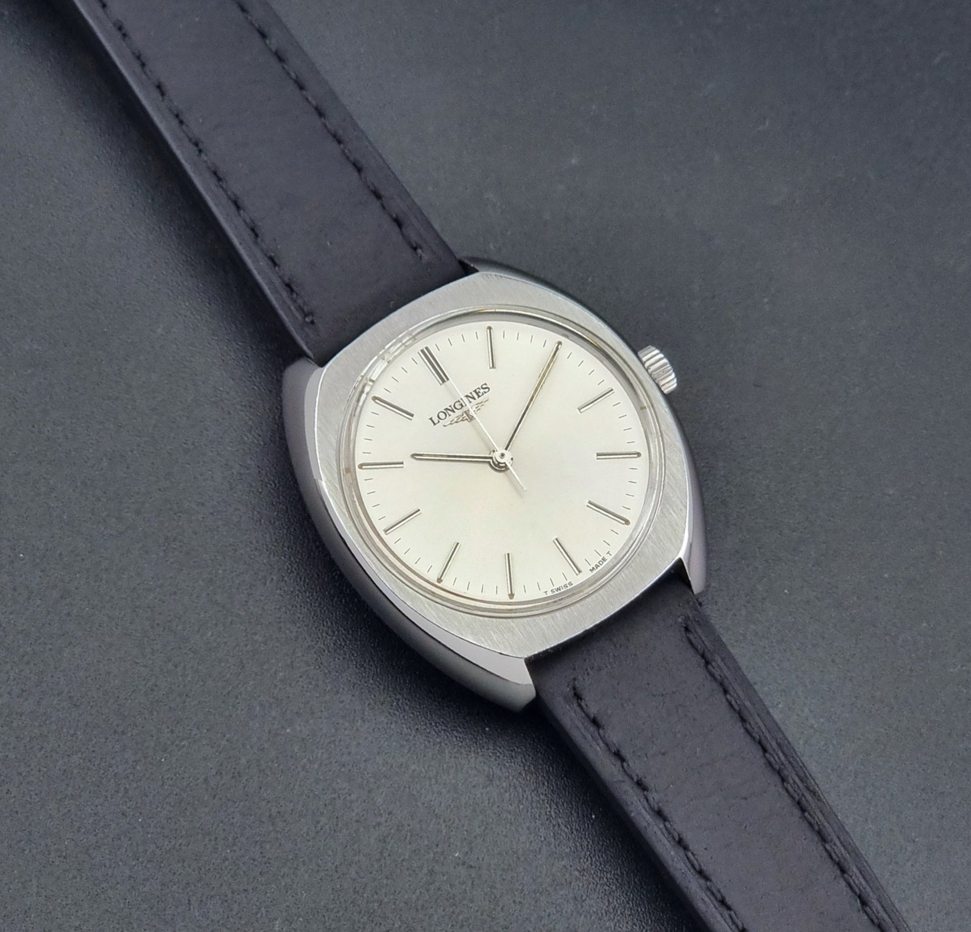 Vintage Longines 1584-1 watch with a black strap on a dark background front view