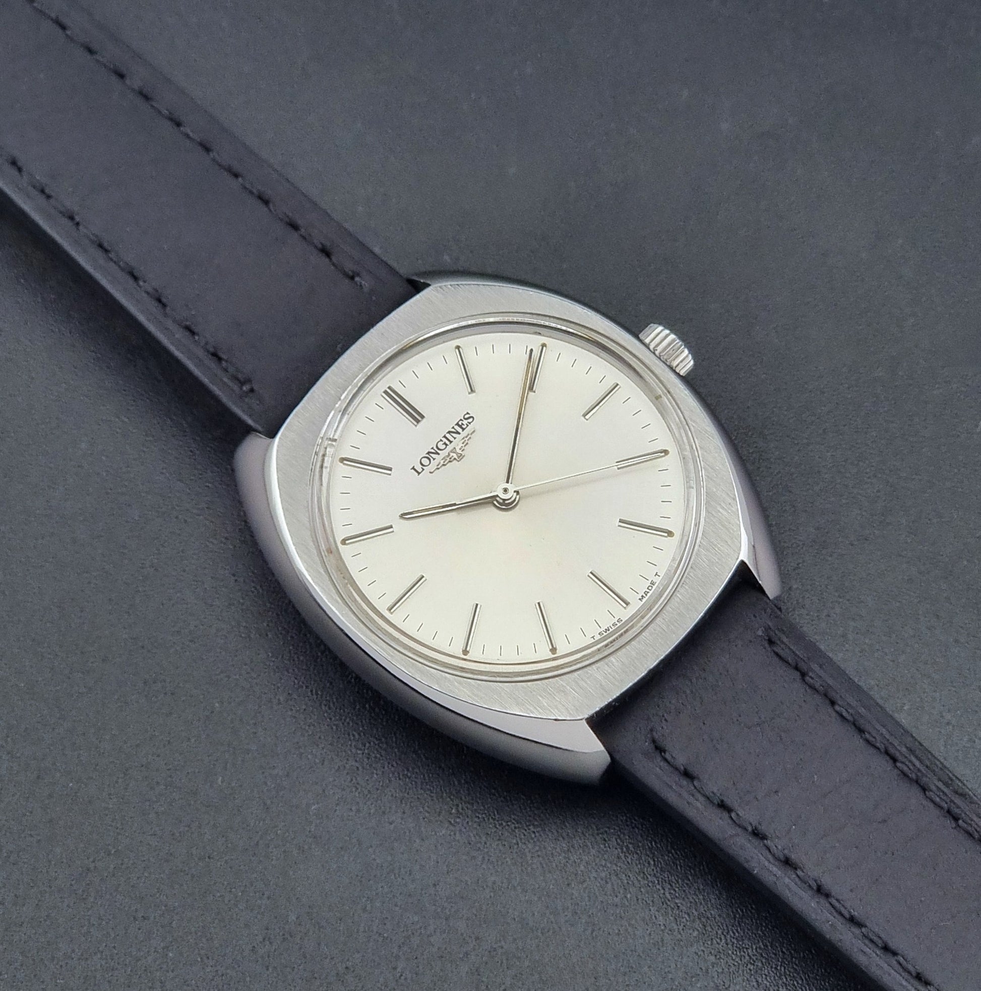Vintage Longines 1584-1 watch with a black strap on a dark background close up dial view