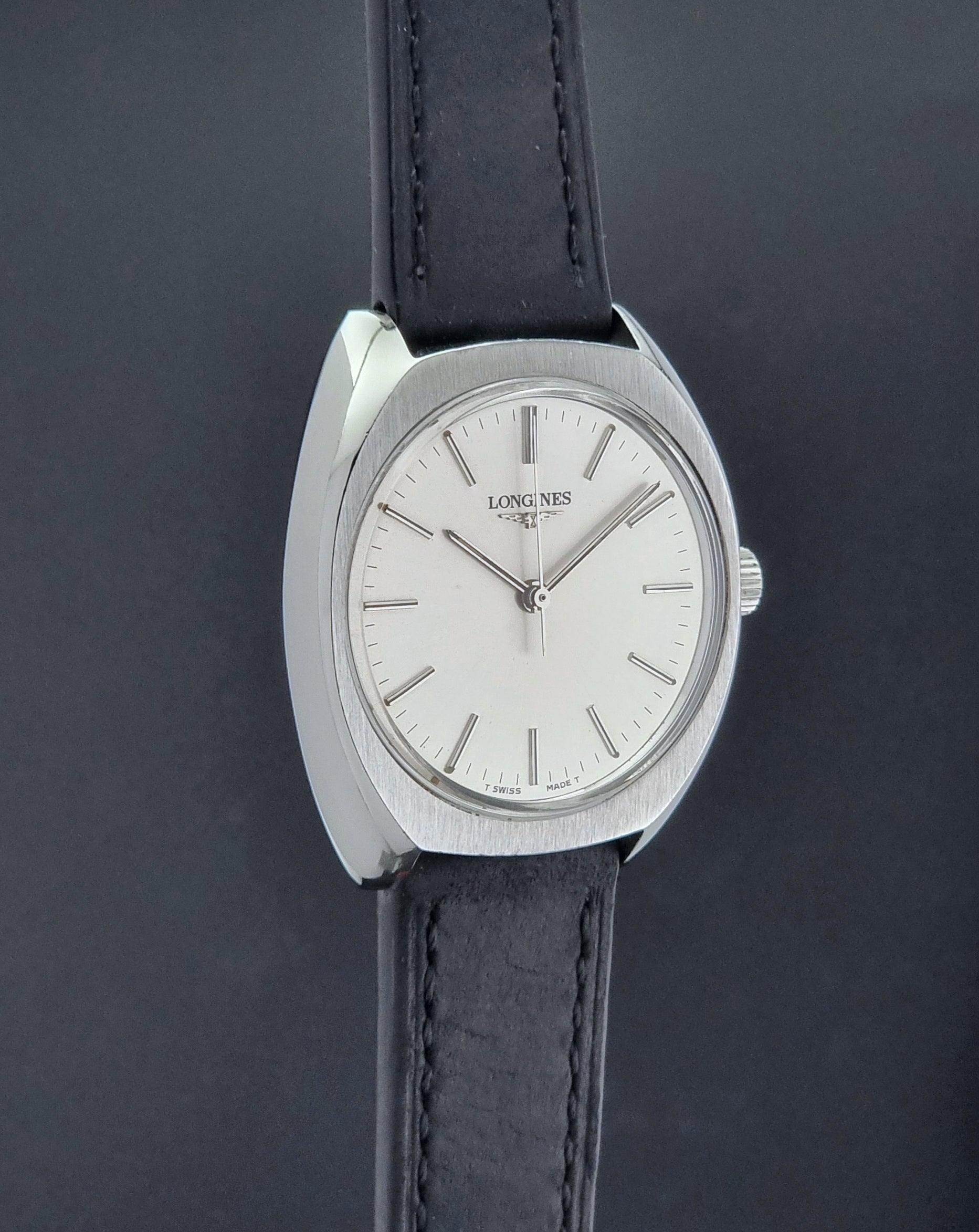 Vintage Longines 1584-1 watch with a black strap on a dark background side profile view