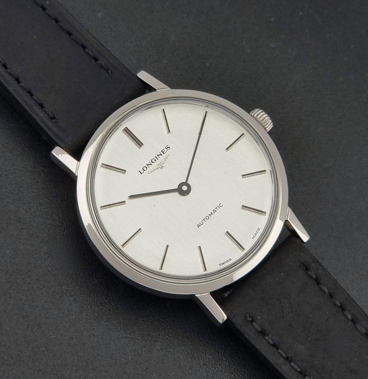 1975 vintage Longines 3029-1 automatic watch, front view highlighting the vertically brushed silver two-hand dial