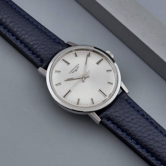 Vintage Longines Wristwatch 7841 with blue leather strap on a grey background dial
