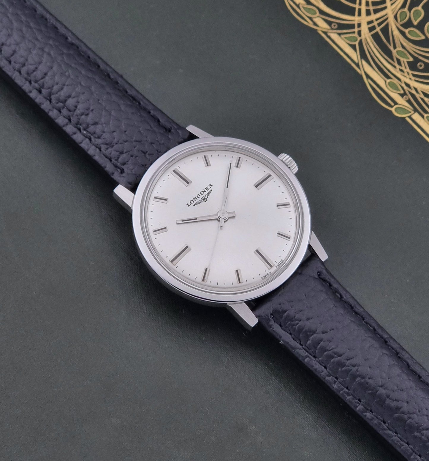 Vintage Longines 8319  Wristwatch with a black leather strap on a dark background dial