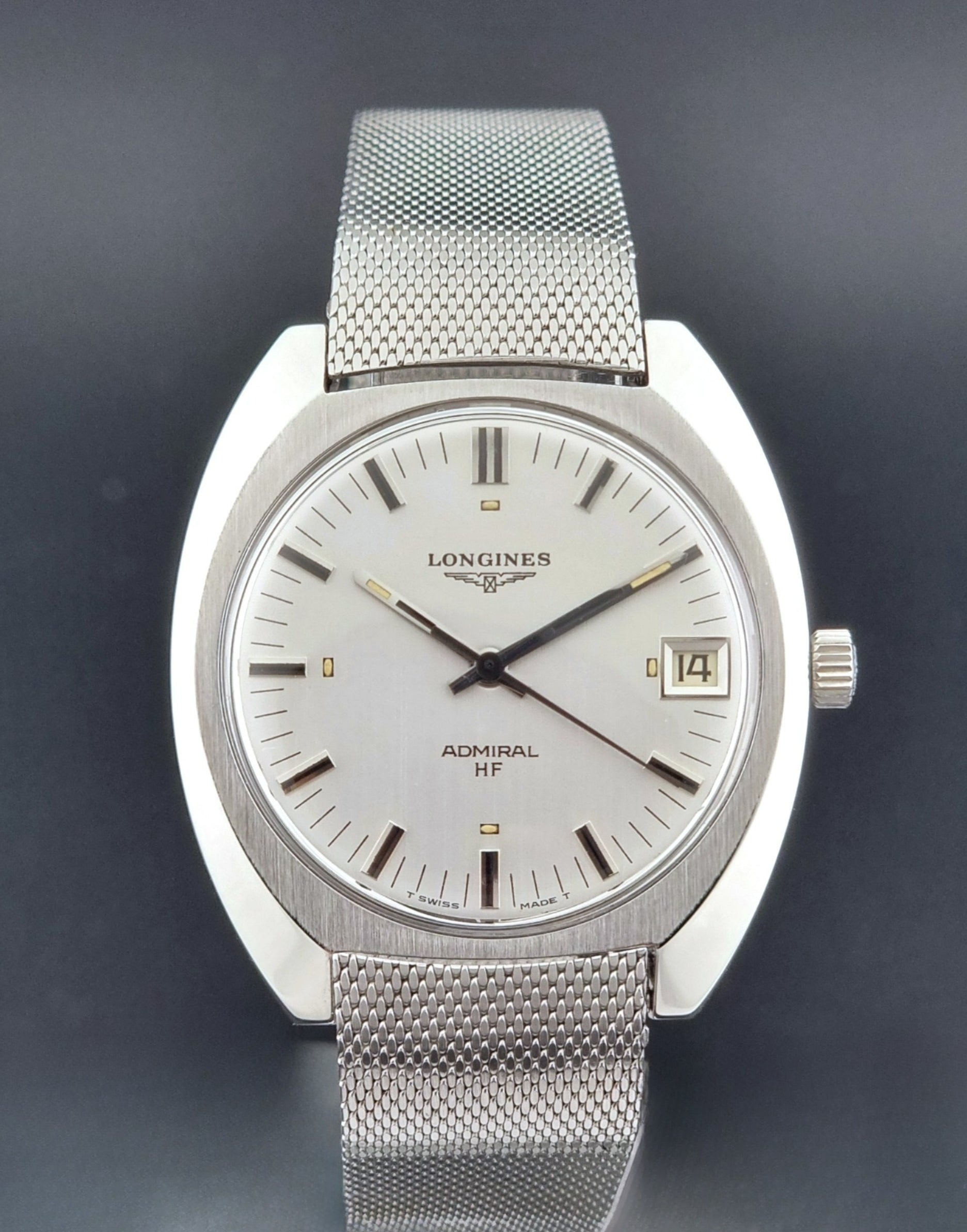 Vintage Longines Admiral Hi frequency Wristwatch 2304-2 with a mesh band on a dark gray background close up dial view