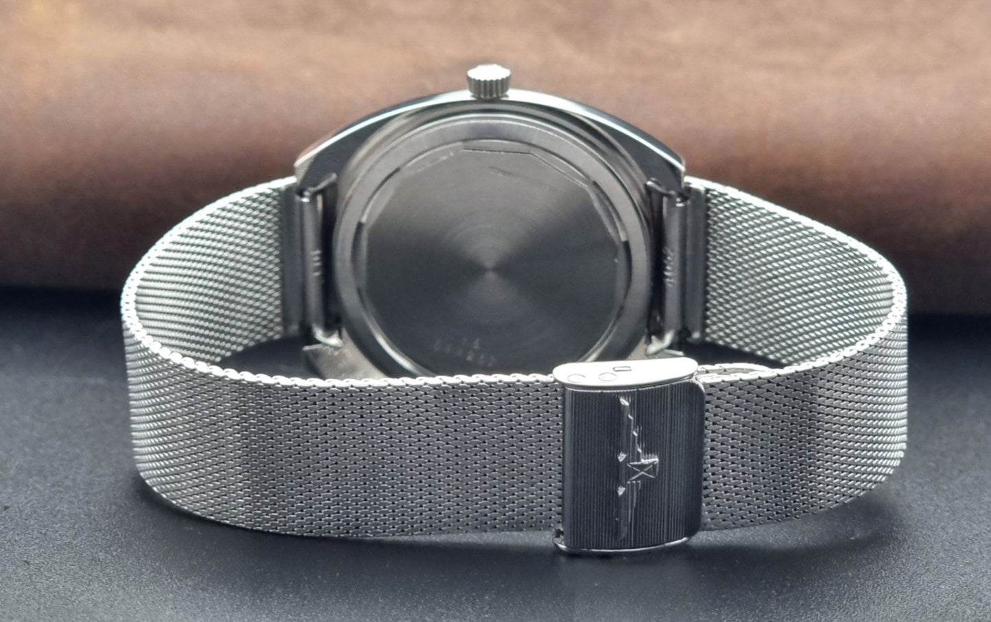 Vintage Longines Admiral Hi frequency Wristwatch 2304-2 with a mesh band on a dark gray background clasp view