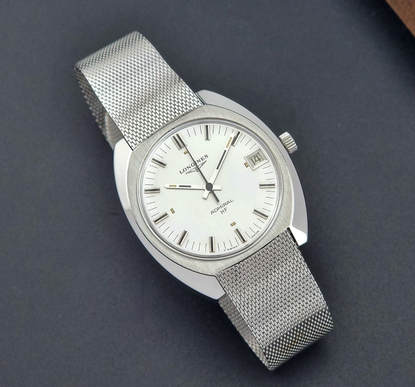 Vintage Longines Admiral Hi frequency Wristwatch 2304-2 with a mesh band on a dark gray background close dial view