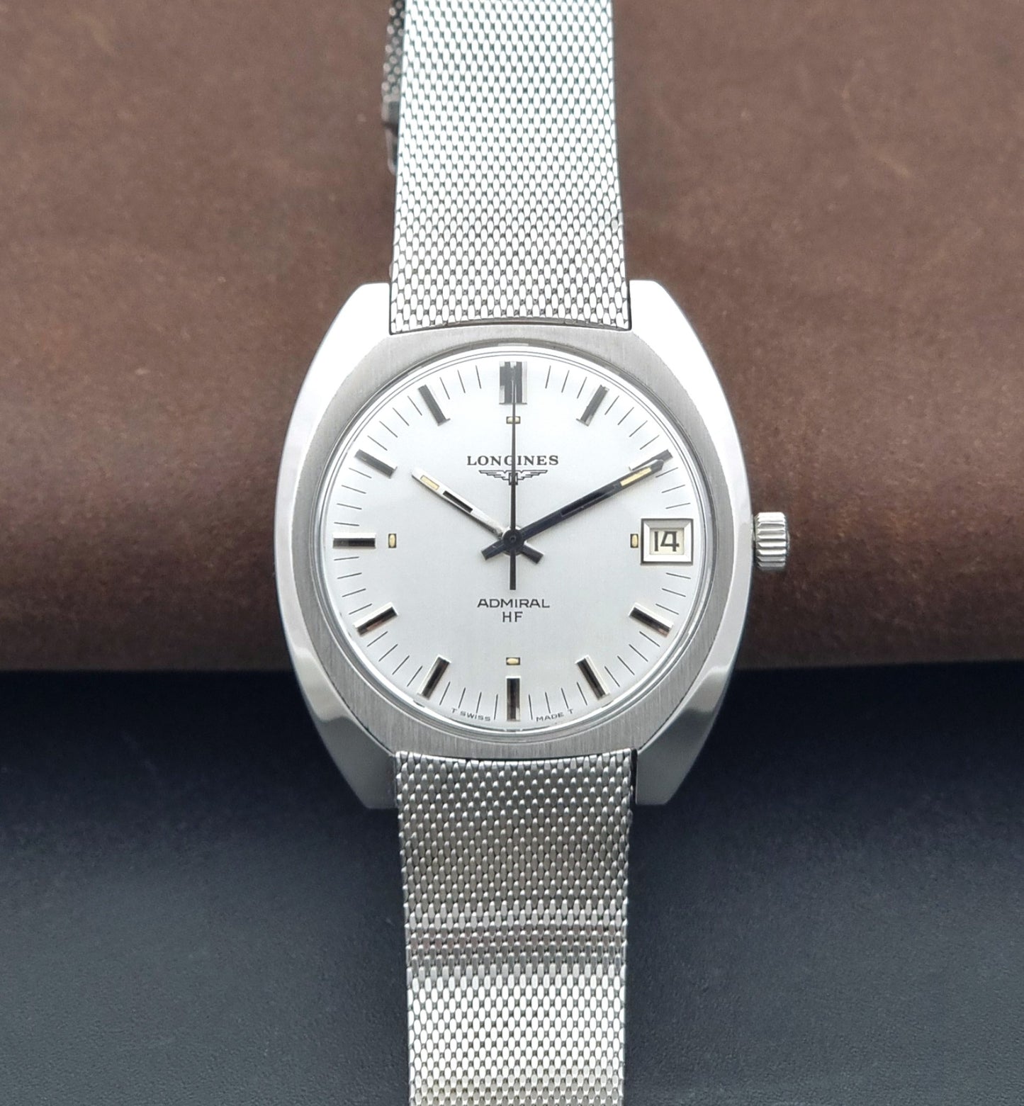 Vintage Longines Admiral Hi frequency Wristwatch 2304-2 with a mesh band on a dark gray background dial view