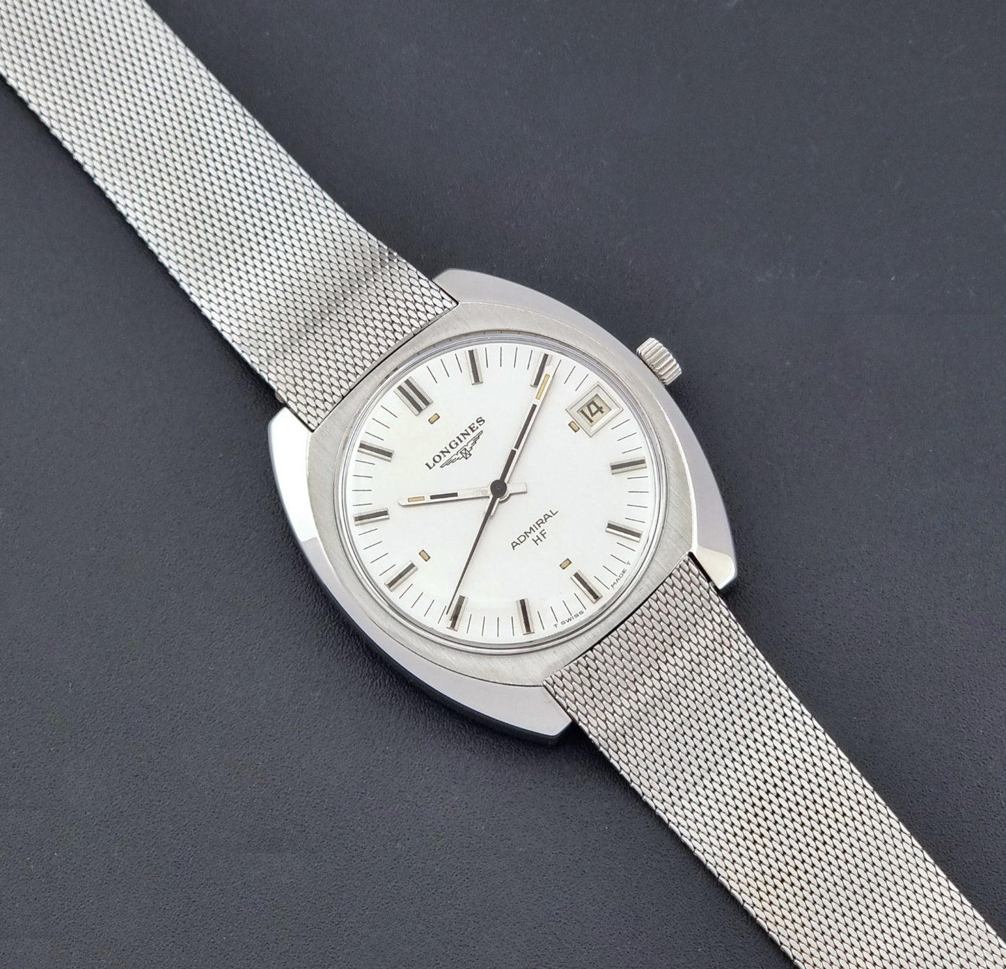 Vintage Longines Admiral Hi frequency Wristwatch 2304-2 with a mesh band on a dark gray background dial
