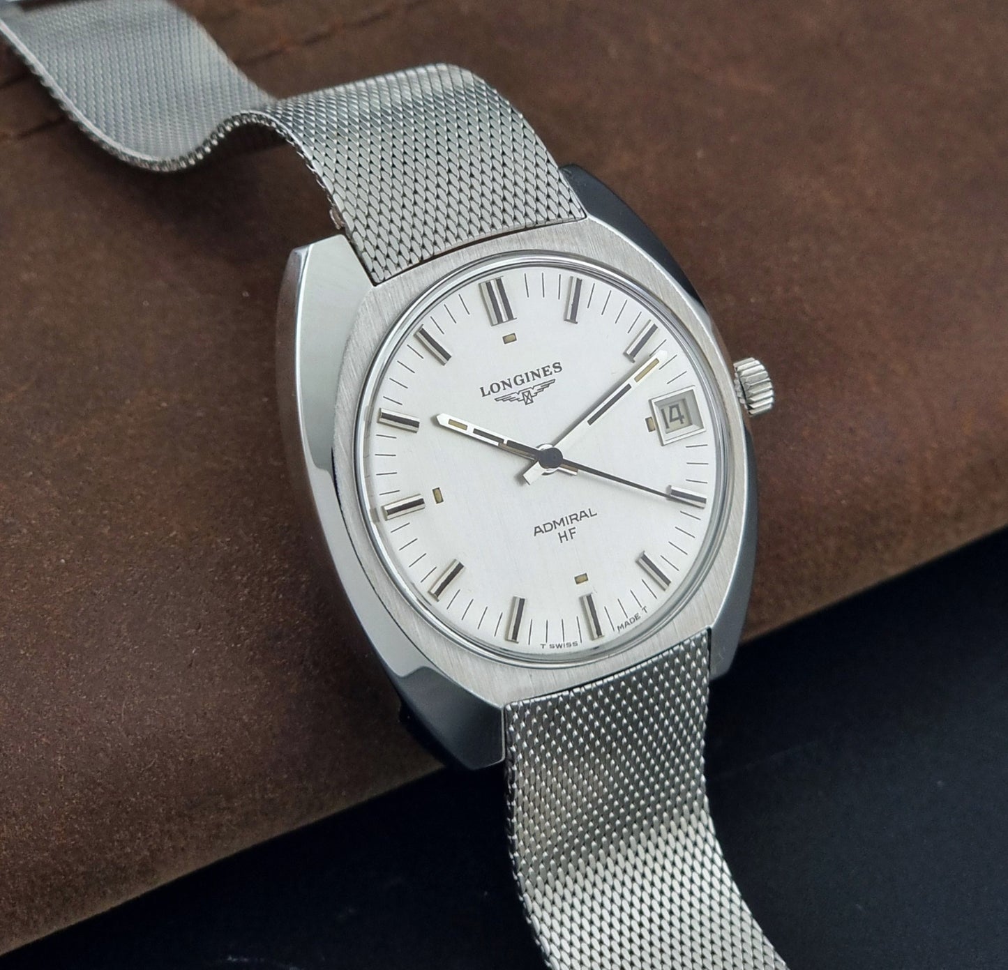Vintage Longines Admiral Hi frequency Wristwatch 2304-2 with a mesh band on a dark gray background side view