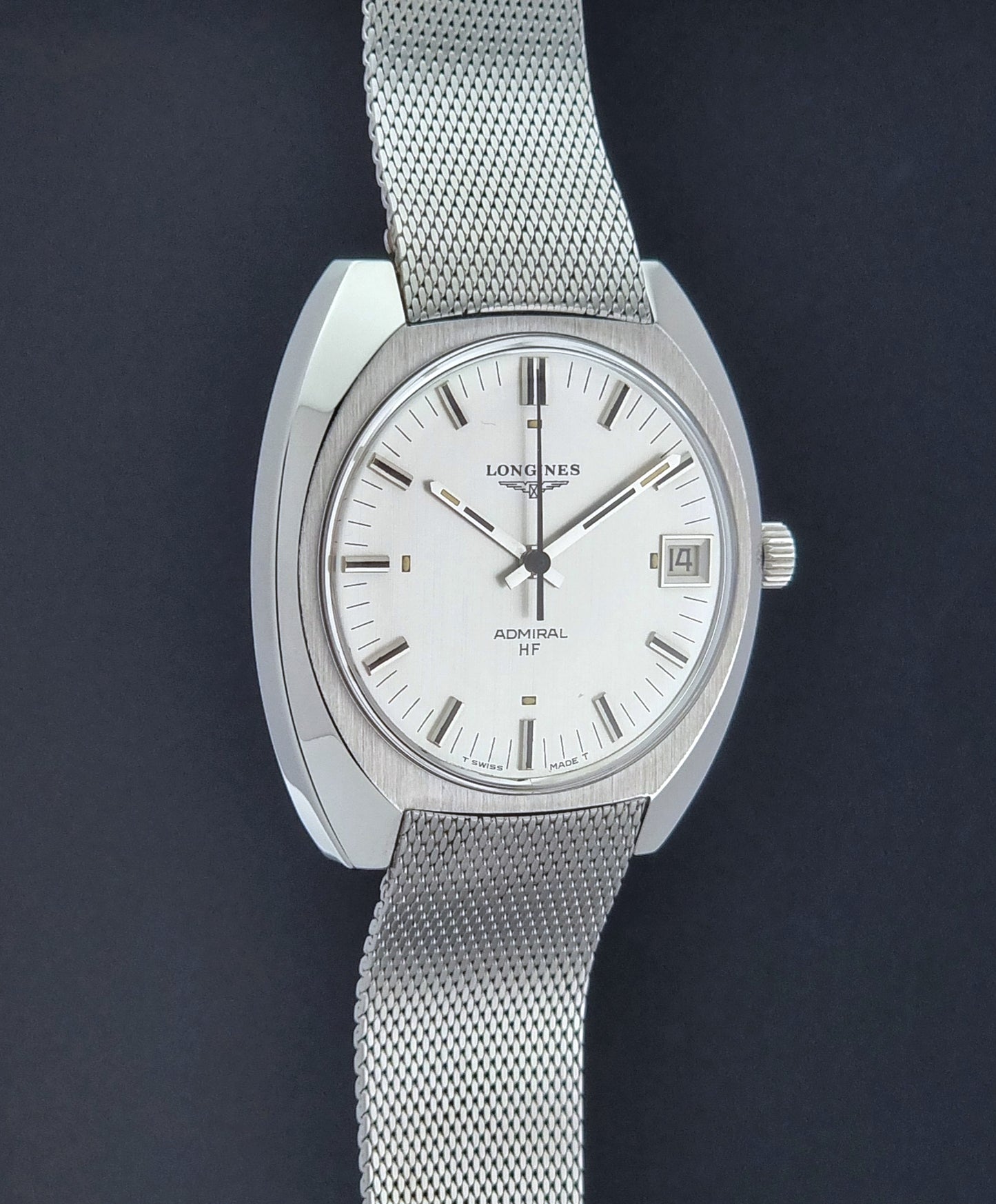 Vintage Longines Admiral Hi frequency Wristwatch 2304-2 with a mesh band on a dark gray background side profile view