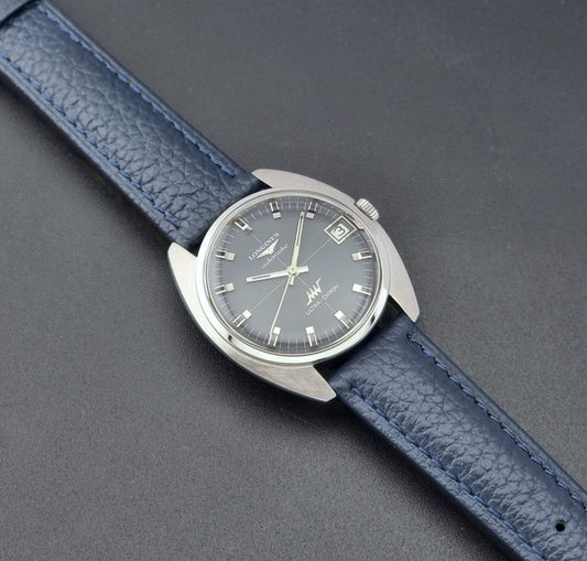 Vintage Longines watch ULTRA-CHRON 8071-2 with blue leather strap and silver case on a dark gray background dial