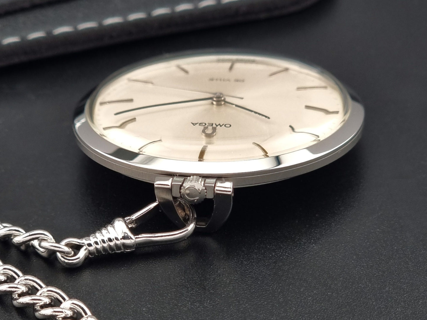Vintage Omega De Ville Pocket Watch 131.1714 on a dark background crown view