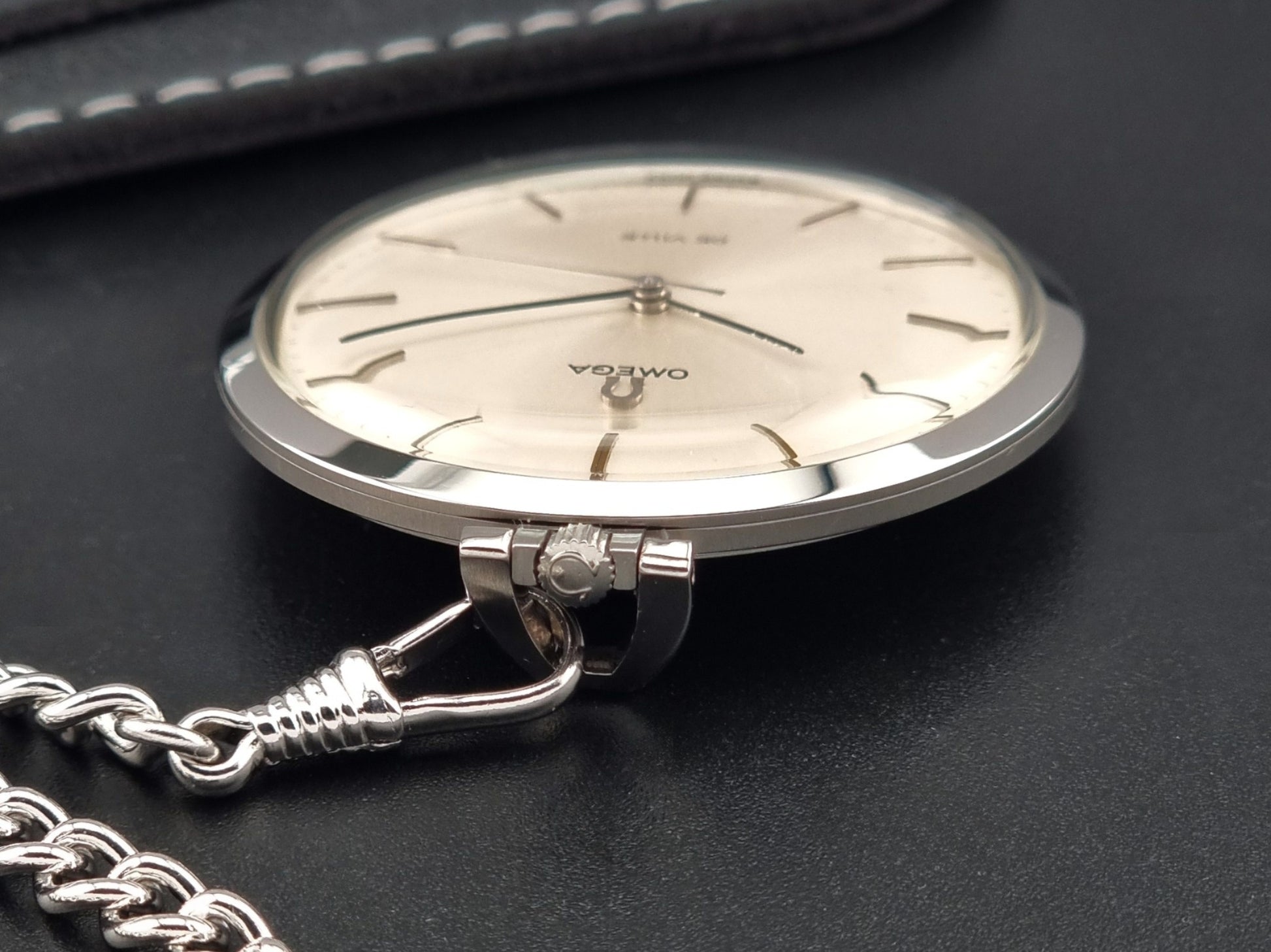Vintage Omega De Ville Pocket Watch 131.1714 on a dark background crown view