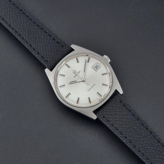 Vintage Omega Geneve 136.041 watch with black strap on a dark background dial

