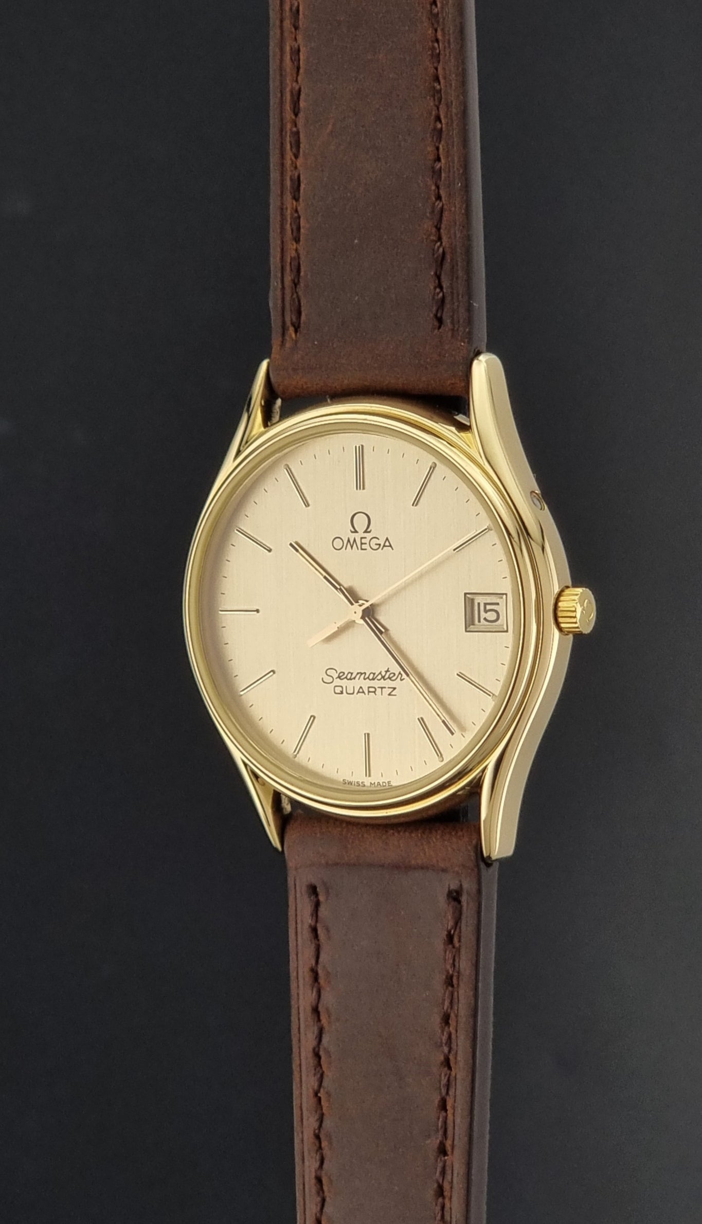 Vintage Omega Quartz Seamaster 196.0281 Wristwatch in a gold case crown profile view