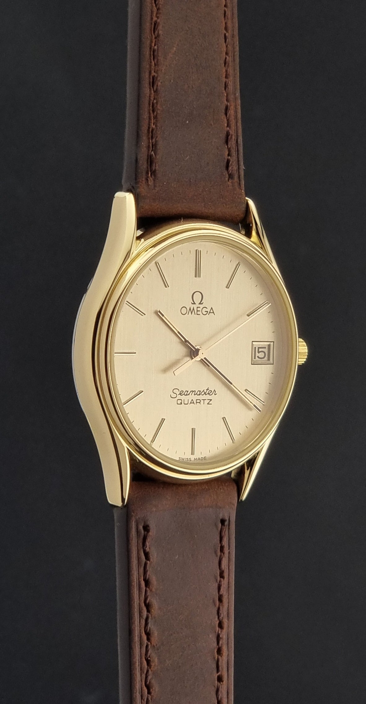 Vintage Omega Quartz Seamaster 196.0281 Wristwatch in a gold case side profile view