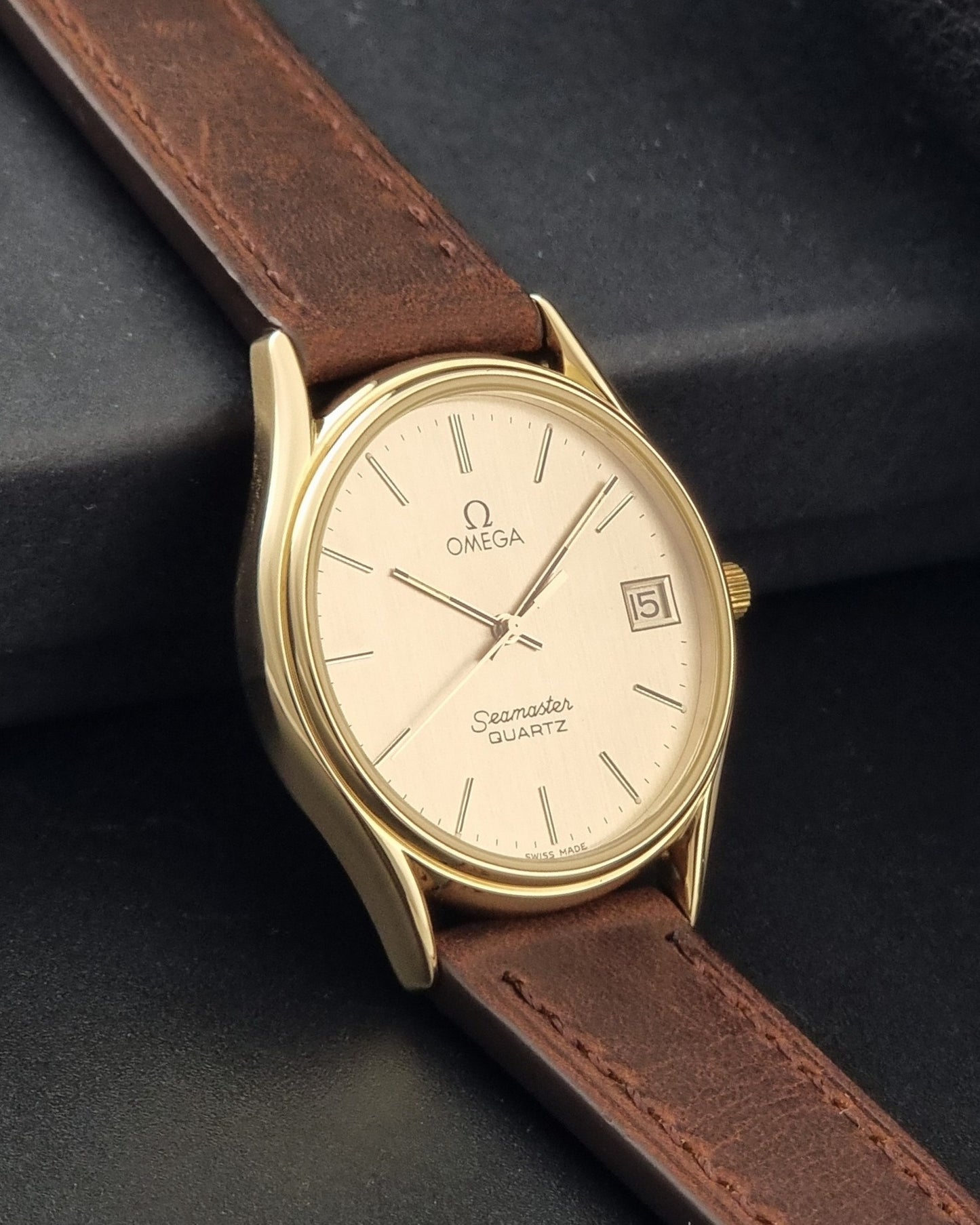 Vintage Omega Quartz Seamaster 196.0281 Wristwatch in a gold case side view