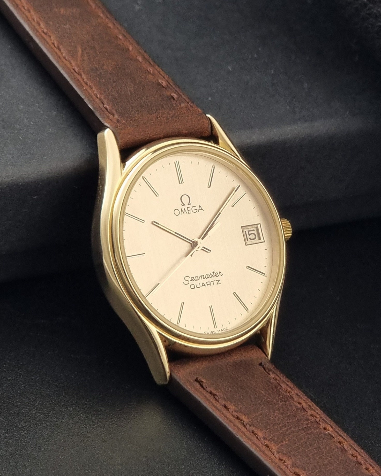 Vintage Omega Quartz Seamaster 196.0281 Wristwatch in a gold case side view