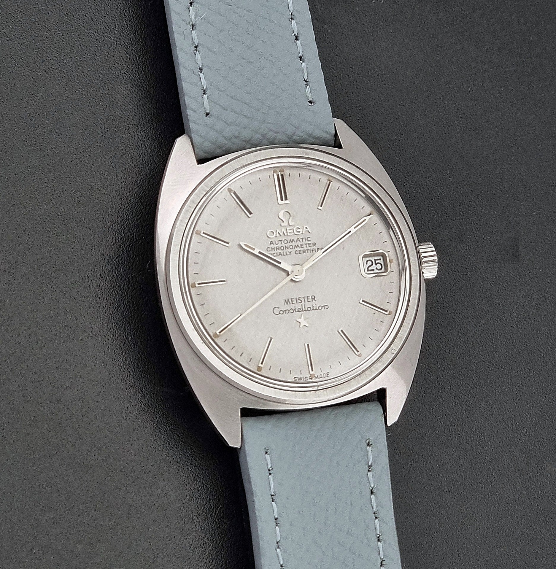Vintage Omega Constellation 168.017 with a grey leather strap on a dark background front view