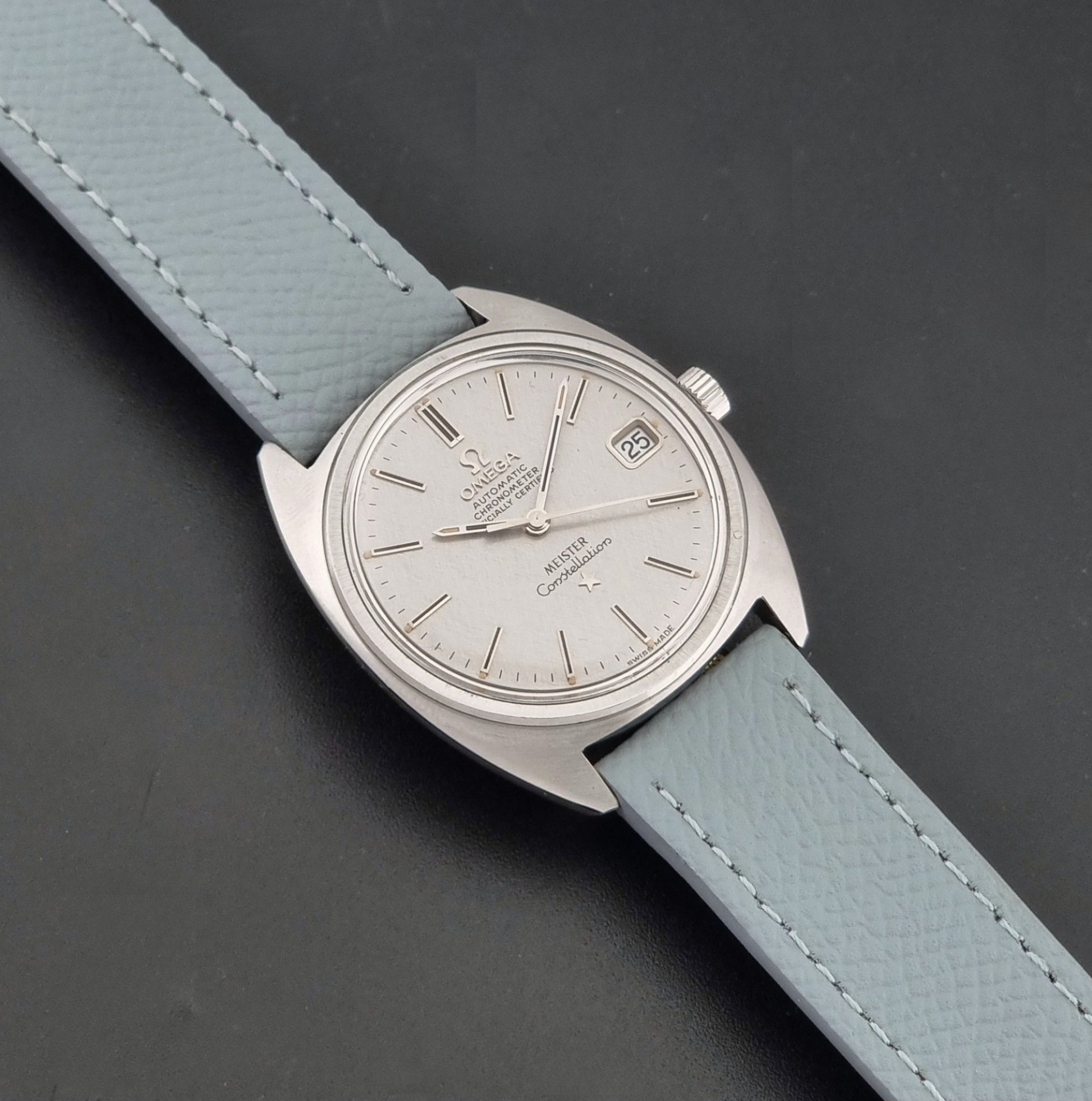 Vintage Omega Constellation 168.017 with a grey leather strap on a dark background dial