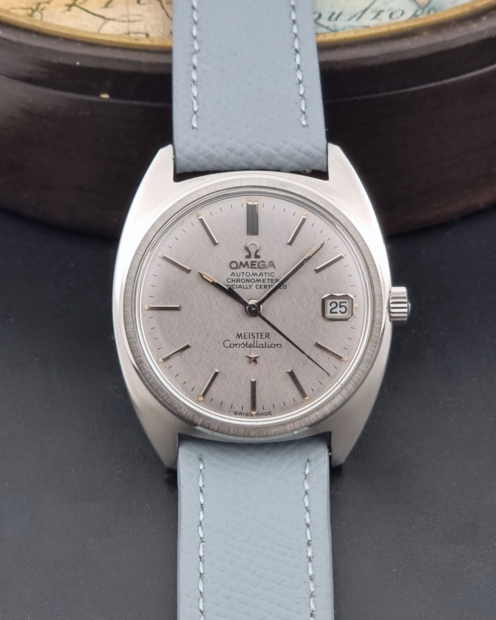 Vintage Omega Constellation 168.017 with a grey leather strap on a dark background dial view