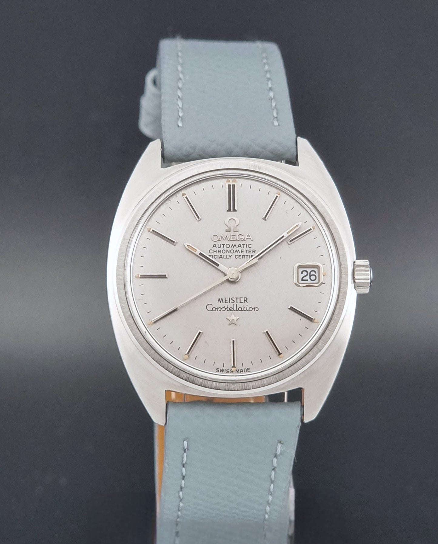 Vintage Omega Constellation 168.017 with a grey leather strap on a dark background close dial view