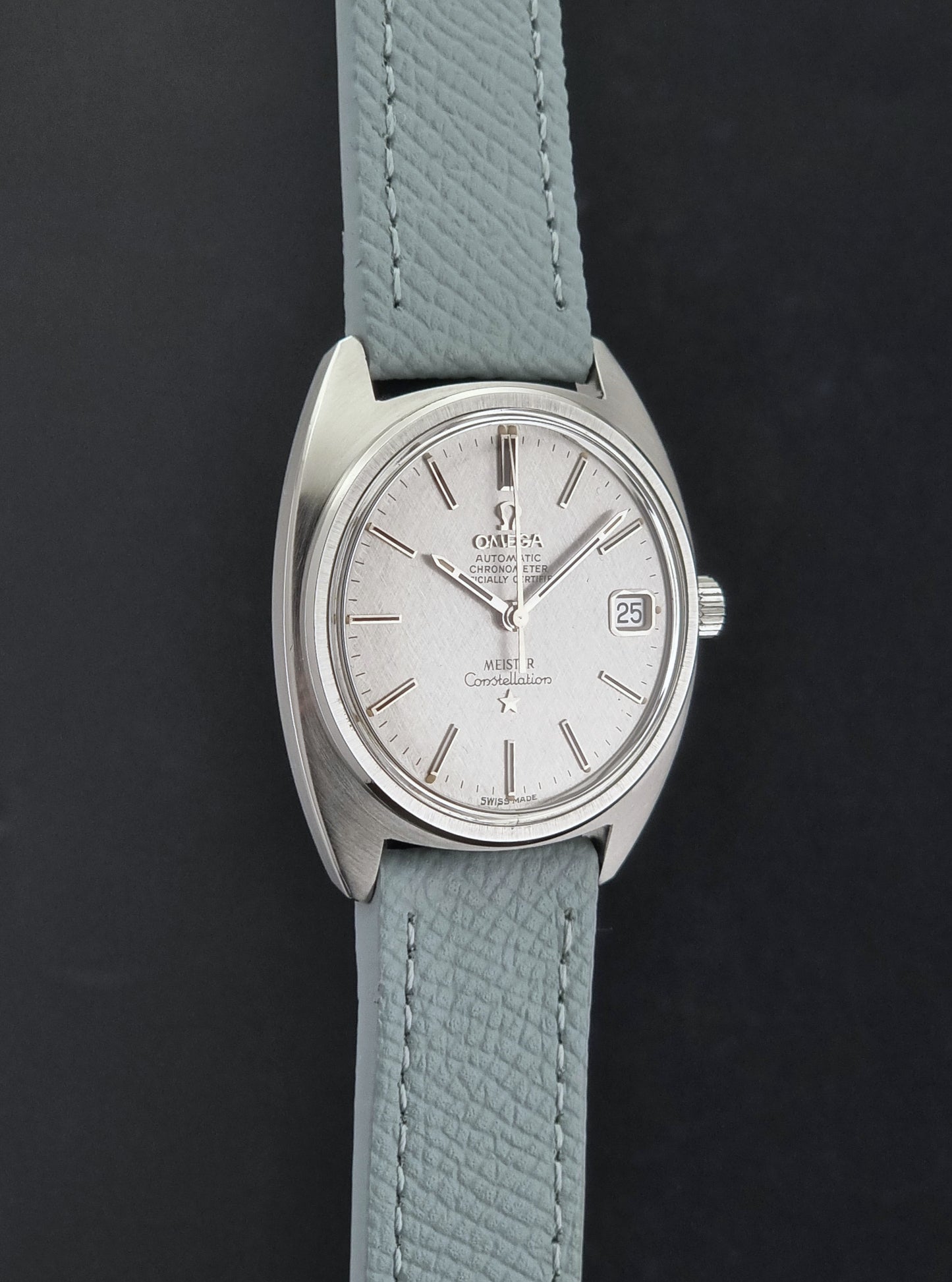 Vintage Omega Constellation 168.017 with a grey leather strap on a dark background side profile view
