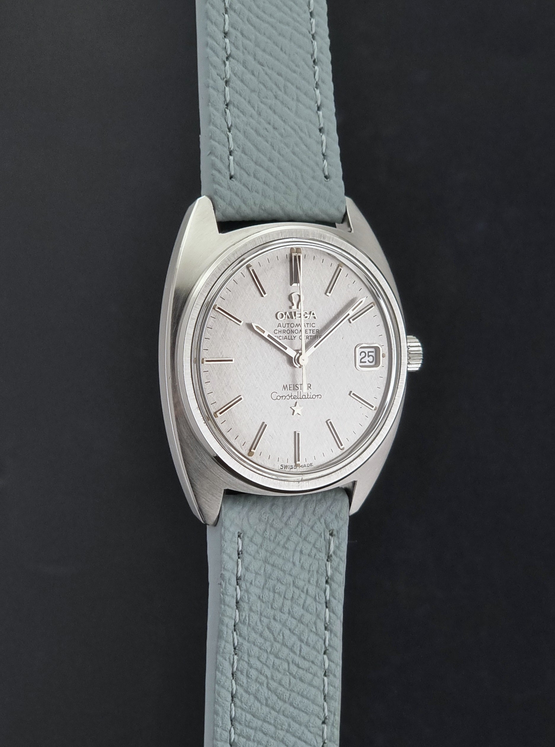 Vintage Omega Constellation 168.017 with a grey leather strap on a dark background side profile view